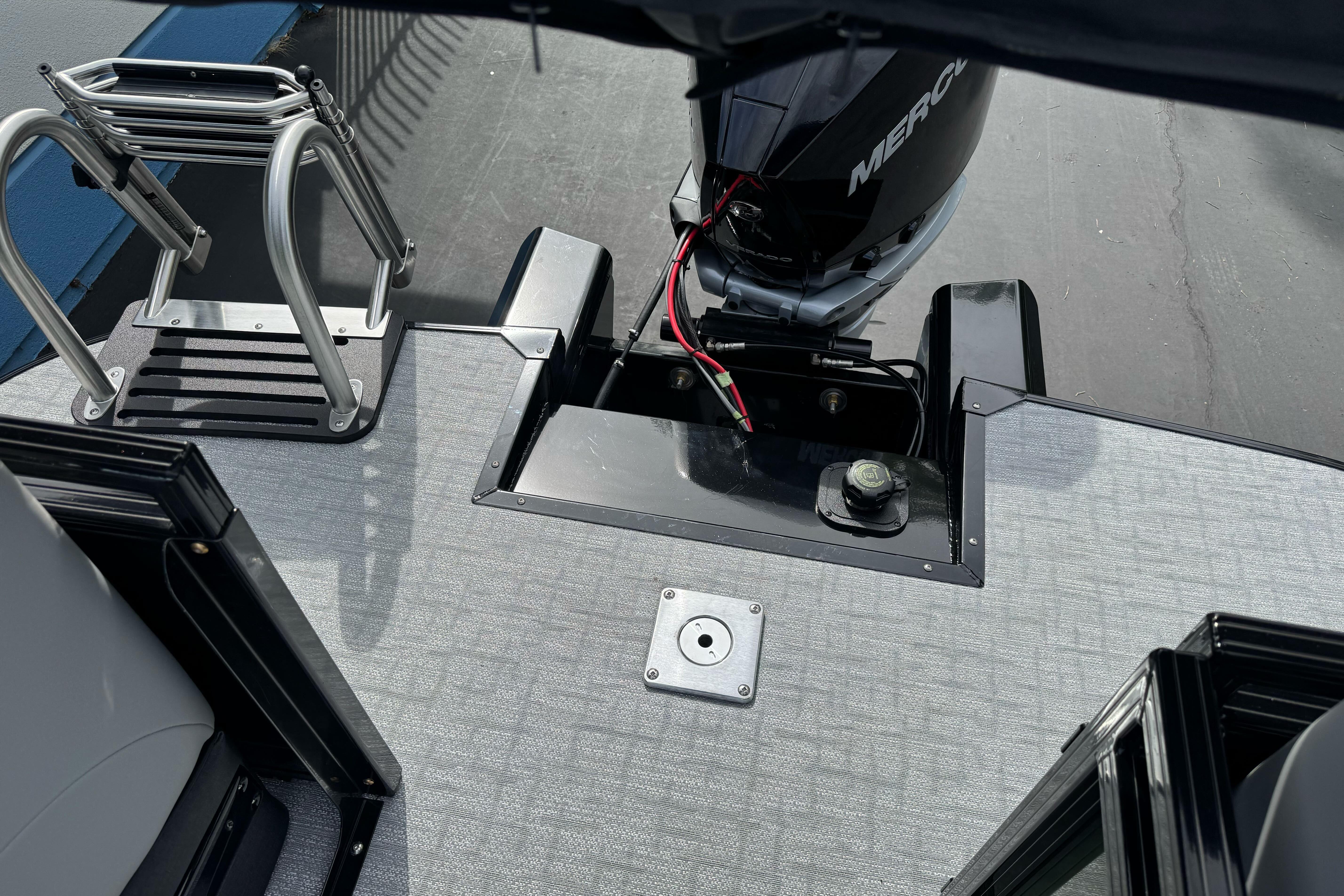 2026 Regency 250 DL boat deck with motor and ladder.