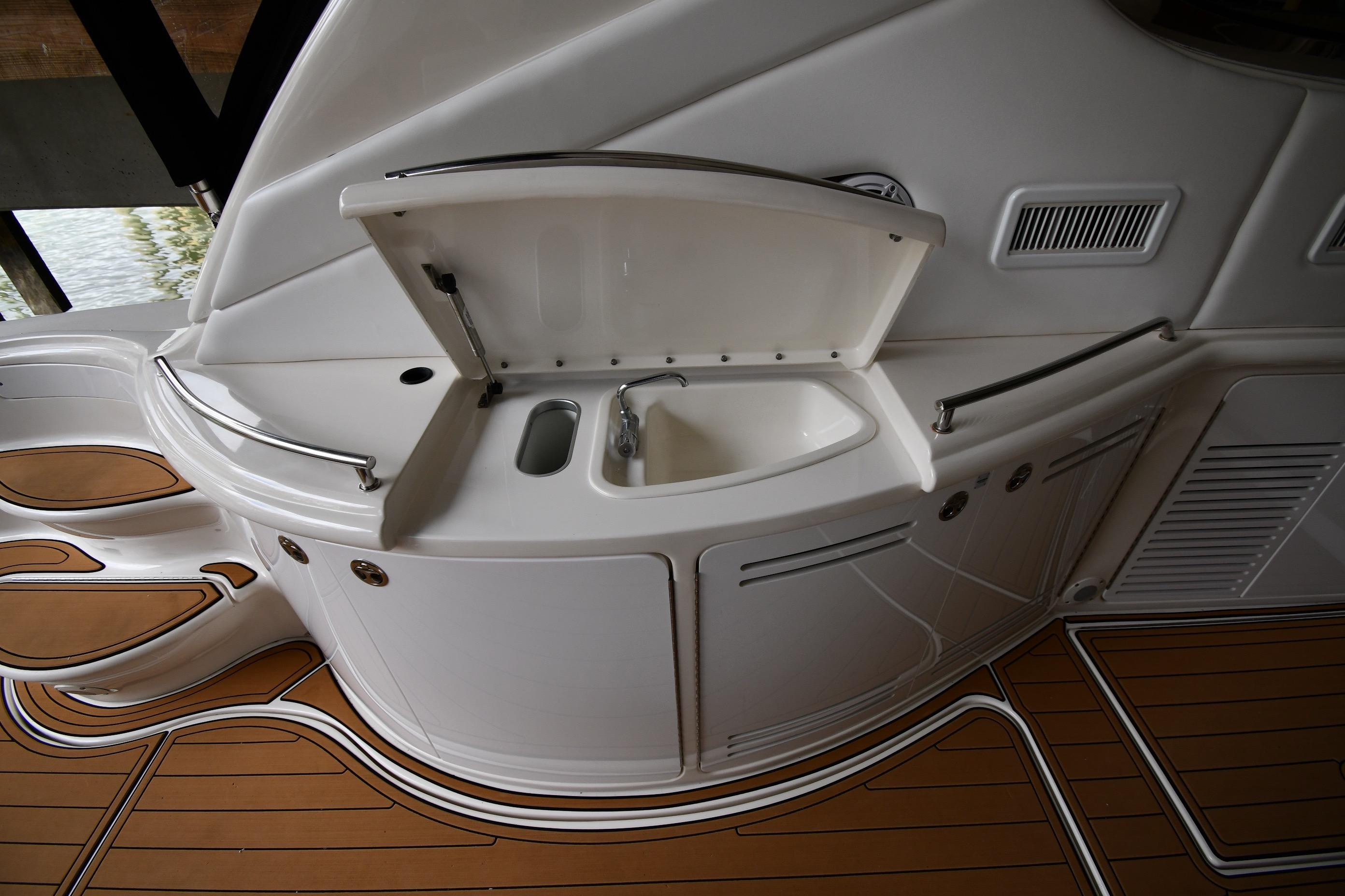 2001 Sea Ray 540 Sundancer yacht interior with sink and teak flooring.