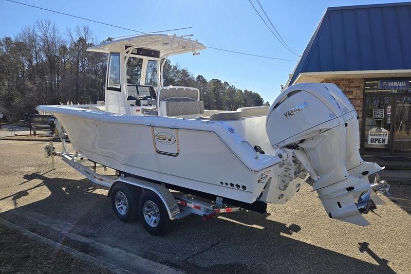 2026 Sea Hunt Ultra 275 Coffin Box boat on trailer, parked outdoors.