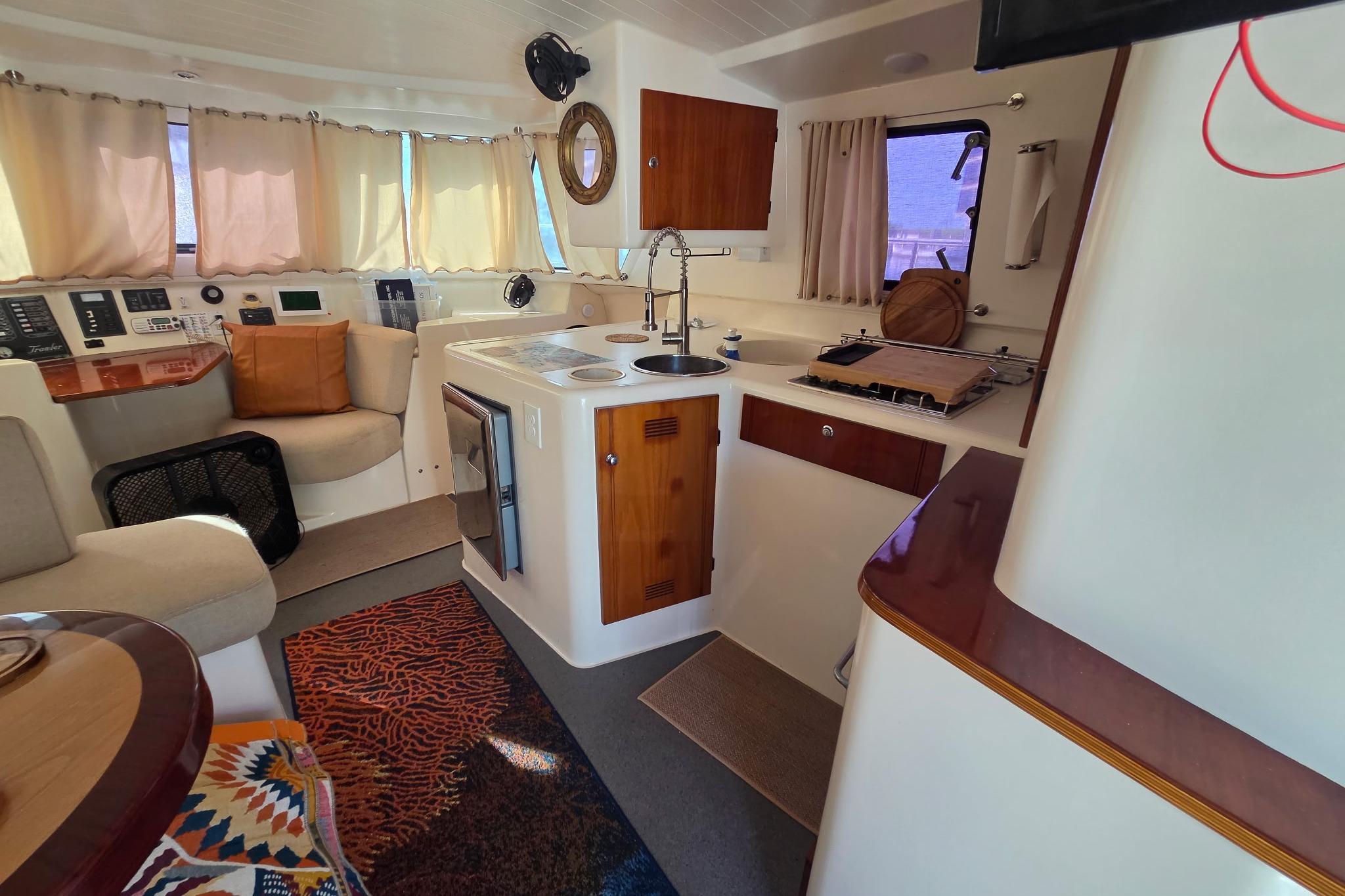 Interior of 2000 Fountaine Pajot Maryland 37 yacht with cozy seating and kitchen area.