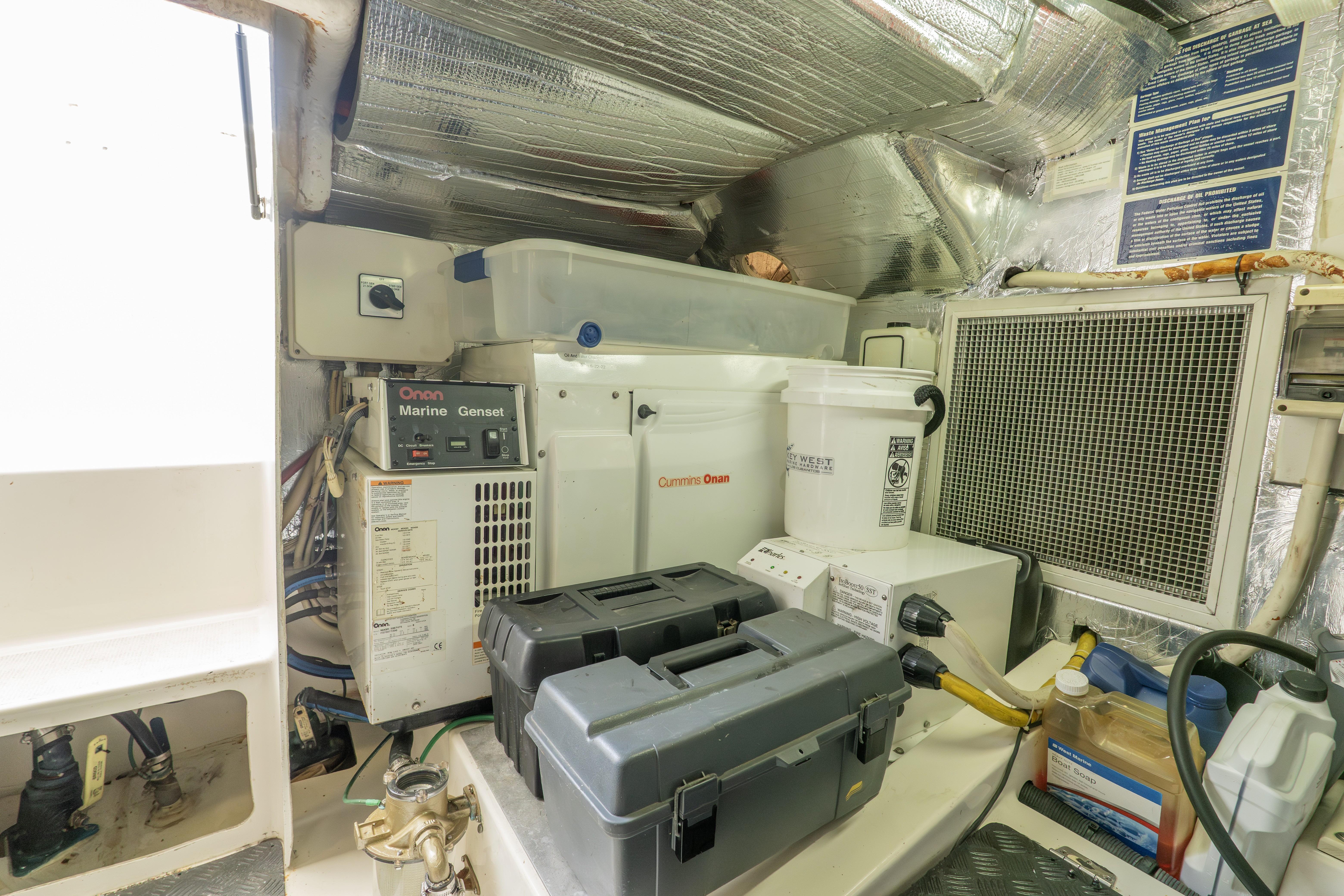 Engine room of 2008 Maritimo 52 yacht with Onan Marine Genset and storage containers.
