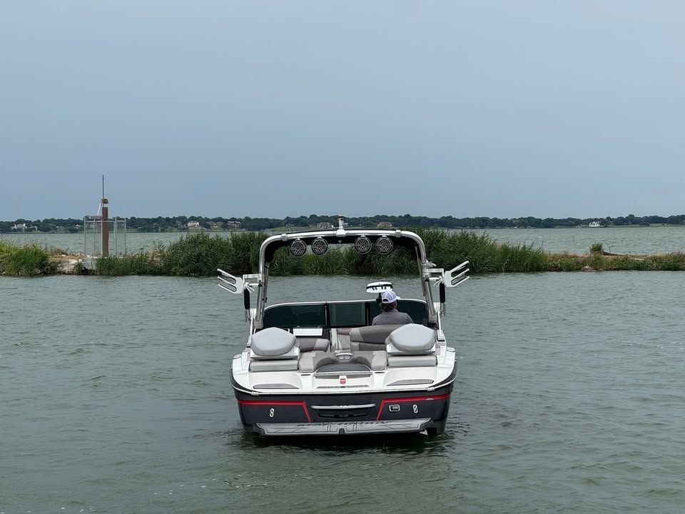 2015 MasterCraft X46 boat on a calm lake.