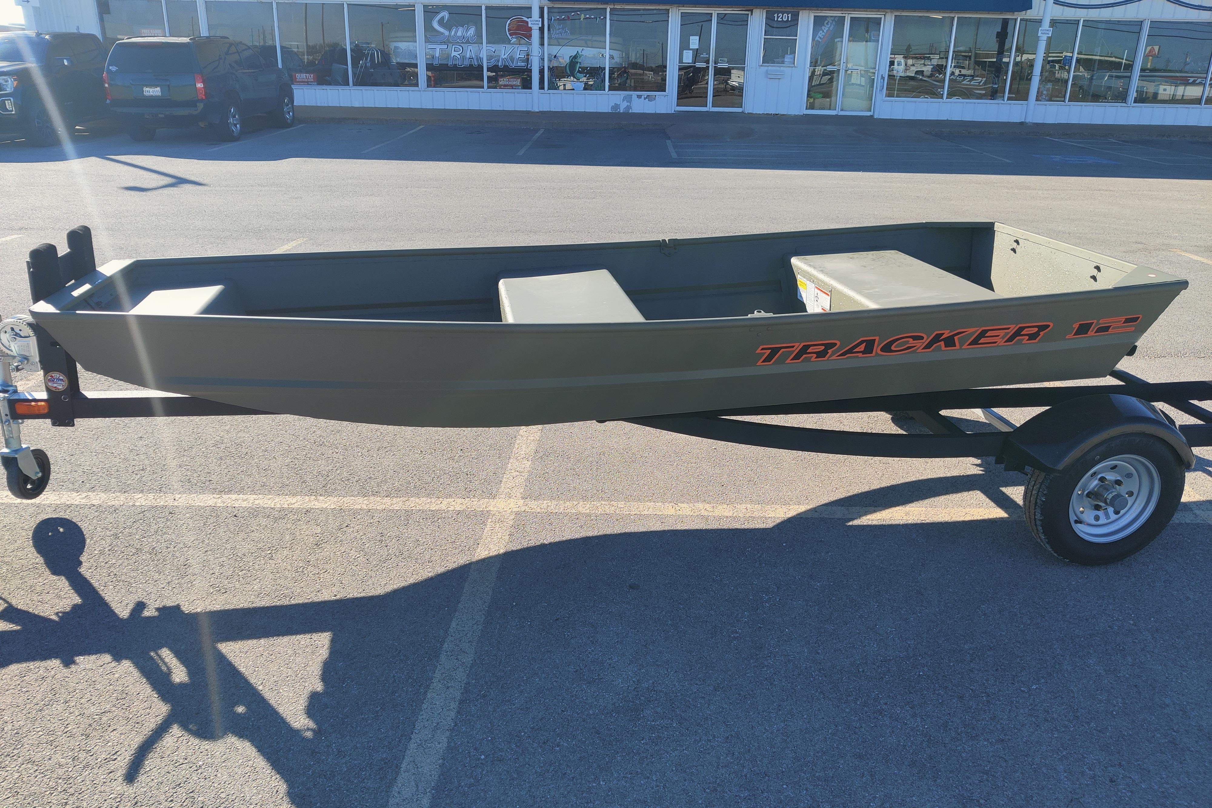 2026 Tracker Grizzly 12 Jon boat on trailer in parking lot.