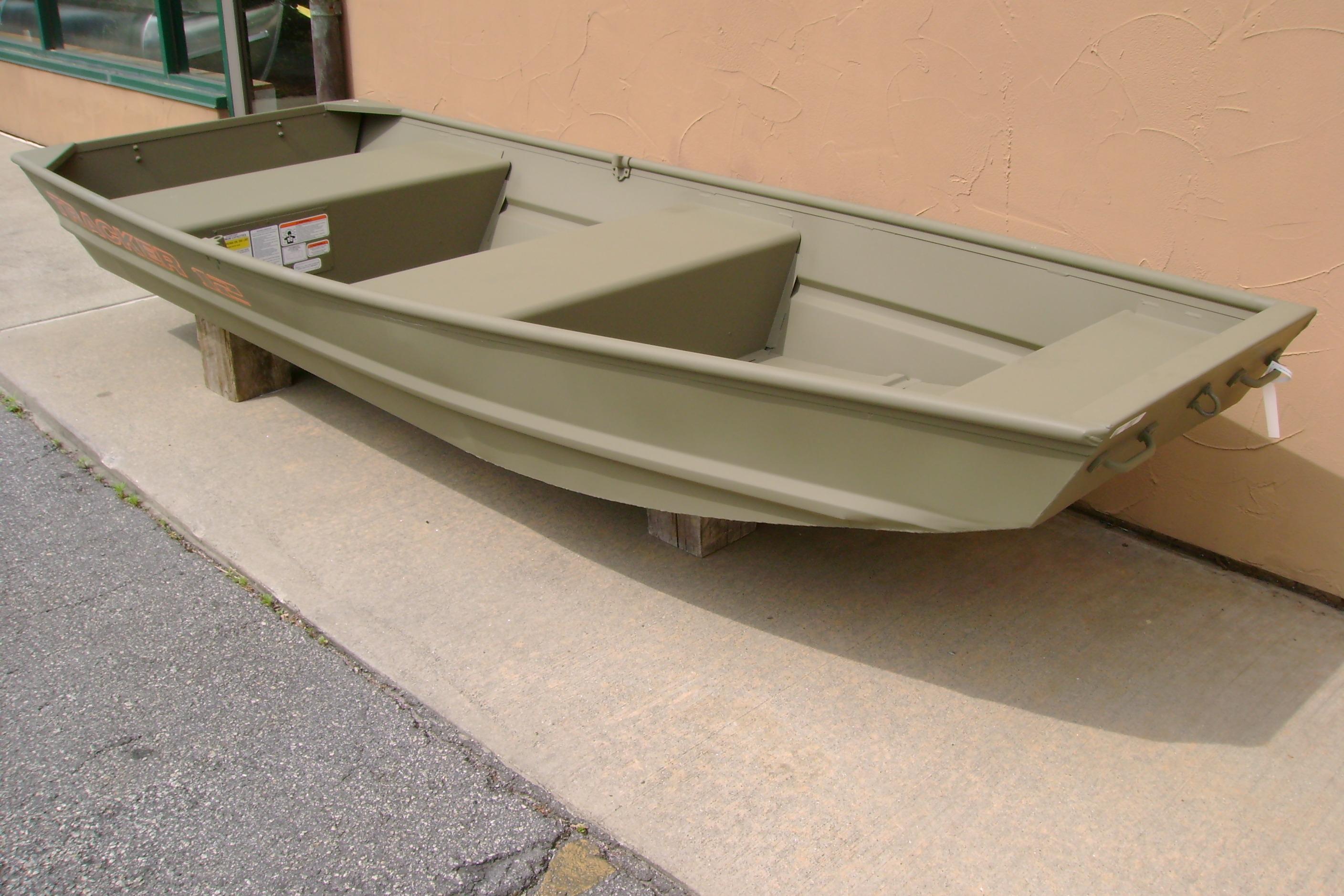 2026 Tracker Grizzly 12 Jon boat displayed outdoors on wooden supports.