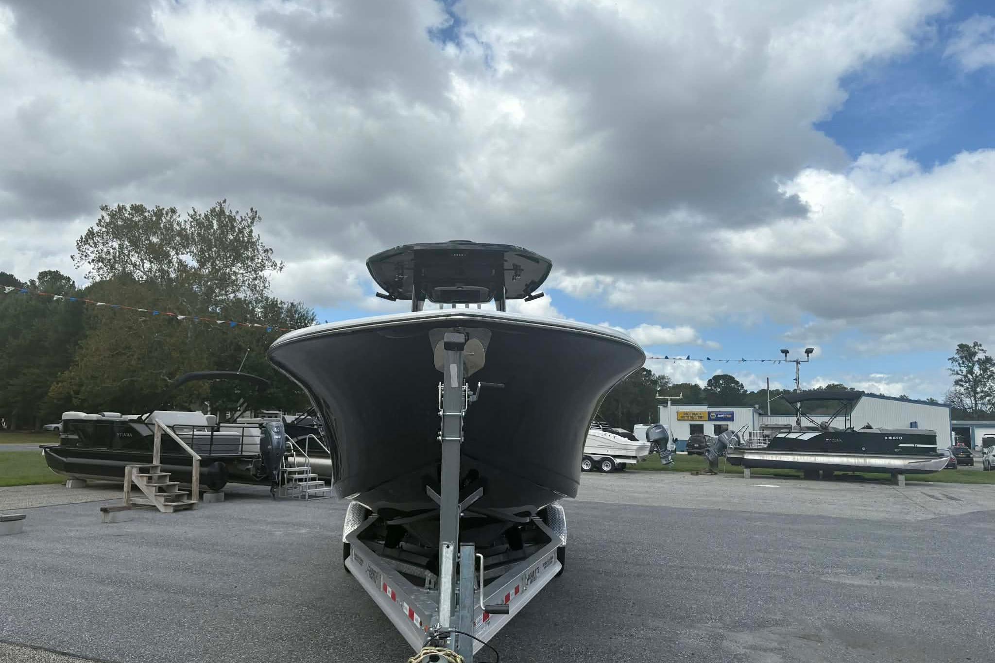 2026 Tidewater 282 CC Adventure boat on trailer under cloudy sky.