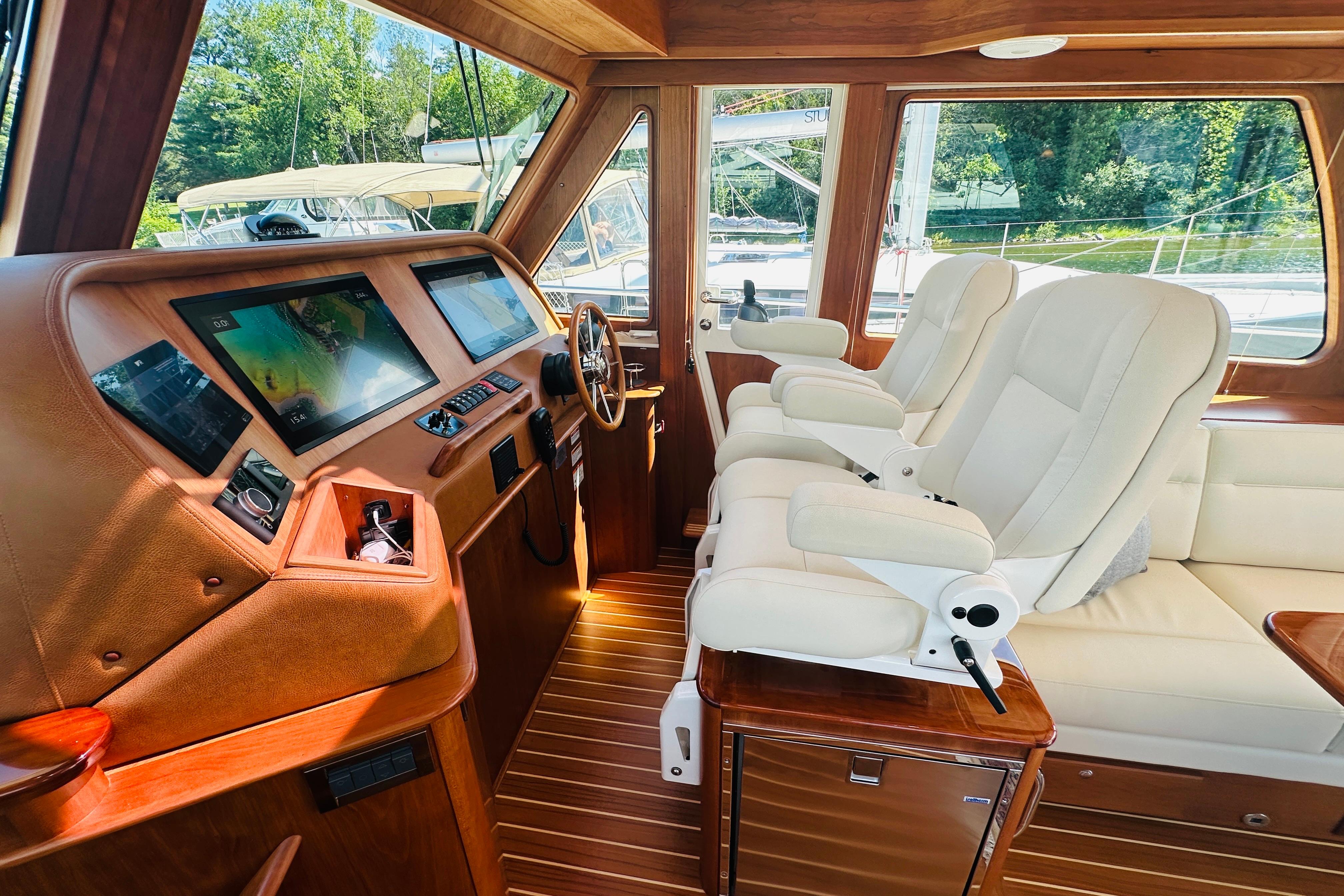 Interior of 2025 Sabre 48 Salon Express yacht with modern navigation system and plush seating.