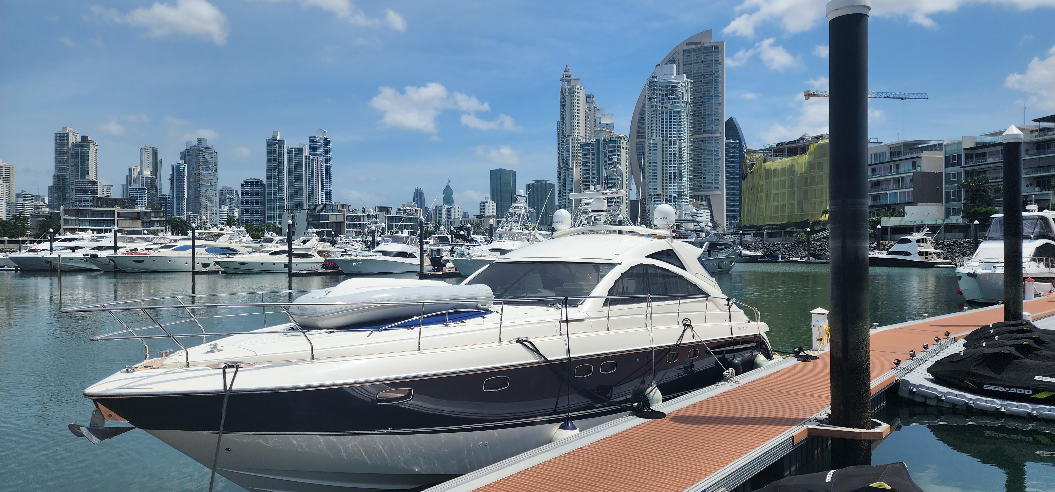 2007 Fairline Targa 52 GT yacht docked in urban marina with city skyline.
