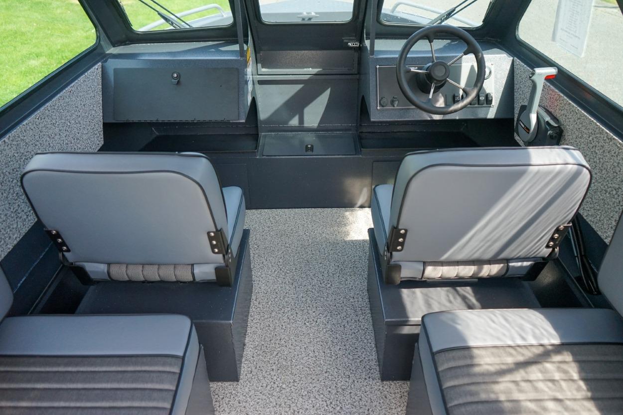 Interior of 2026 Alumaweld X202 Stryker boat with seating and steering wheel.