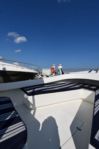 2021 Eastern 248 Center Console boat with blue-striped seating under a clear blue sky.