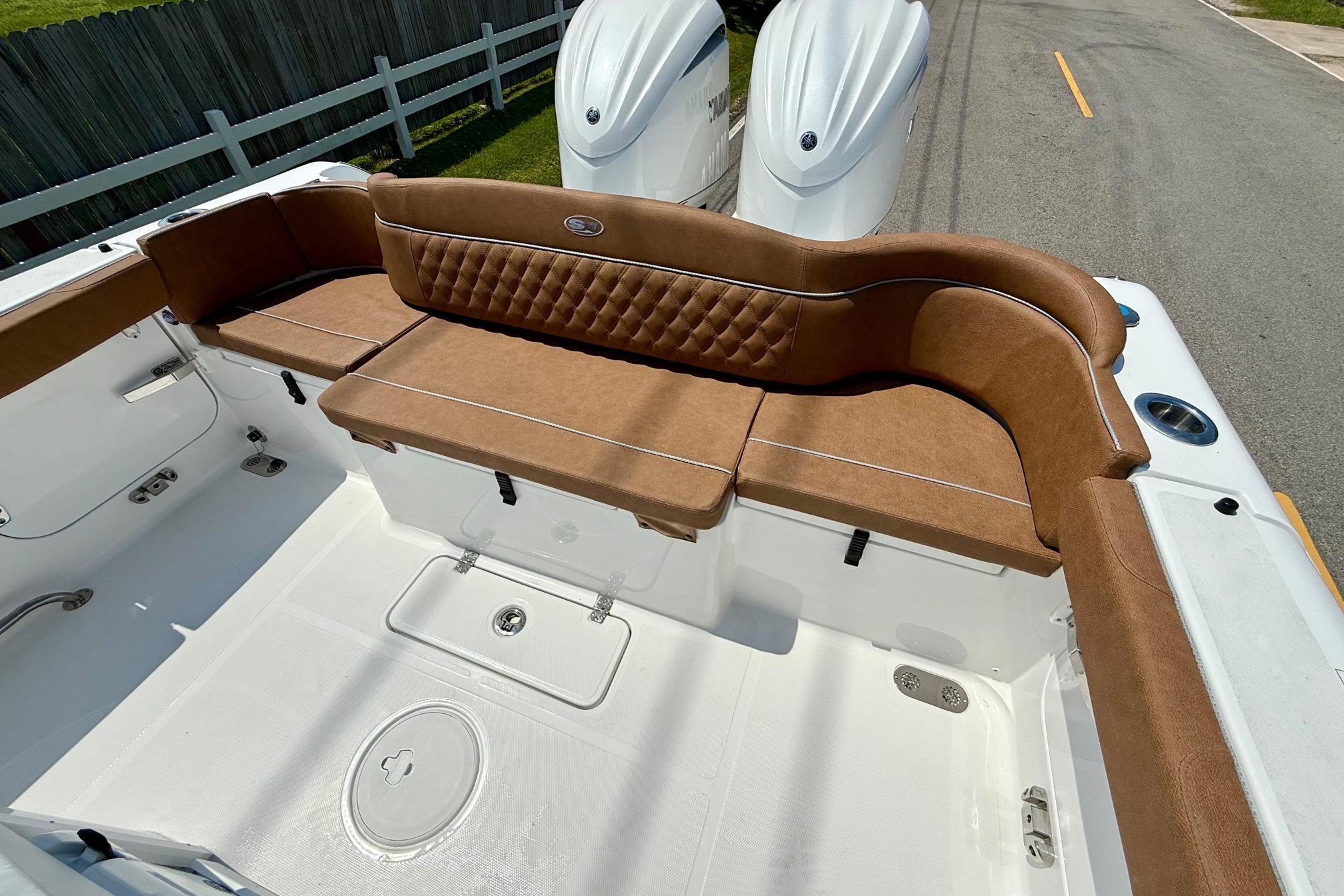 2026 Sea Hunt Ultra 305 SE boat interior with brown cushioned seating.