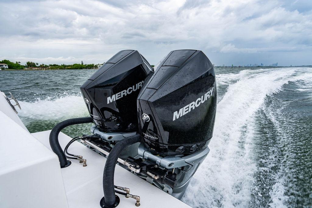 Twin Mercury outboard engines powering a 2027 Reef Runner 280 boat on open water.