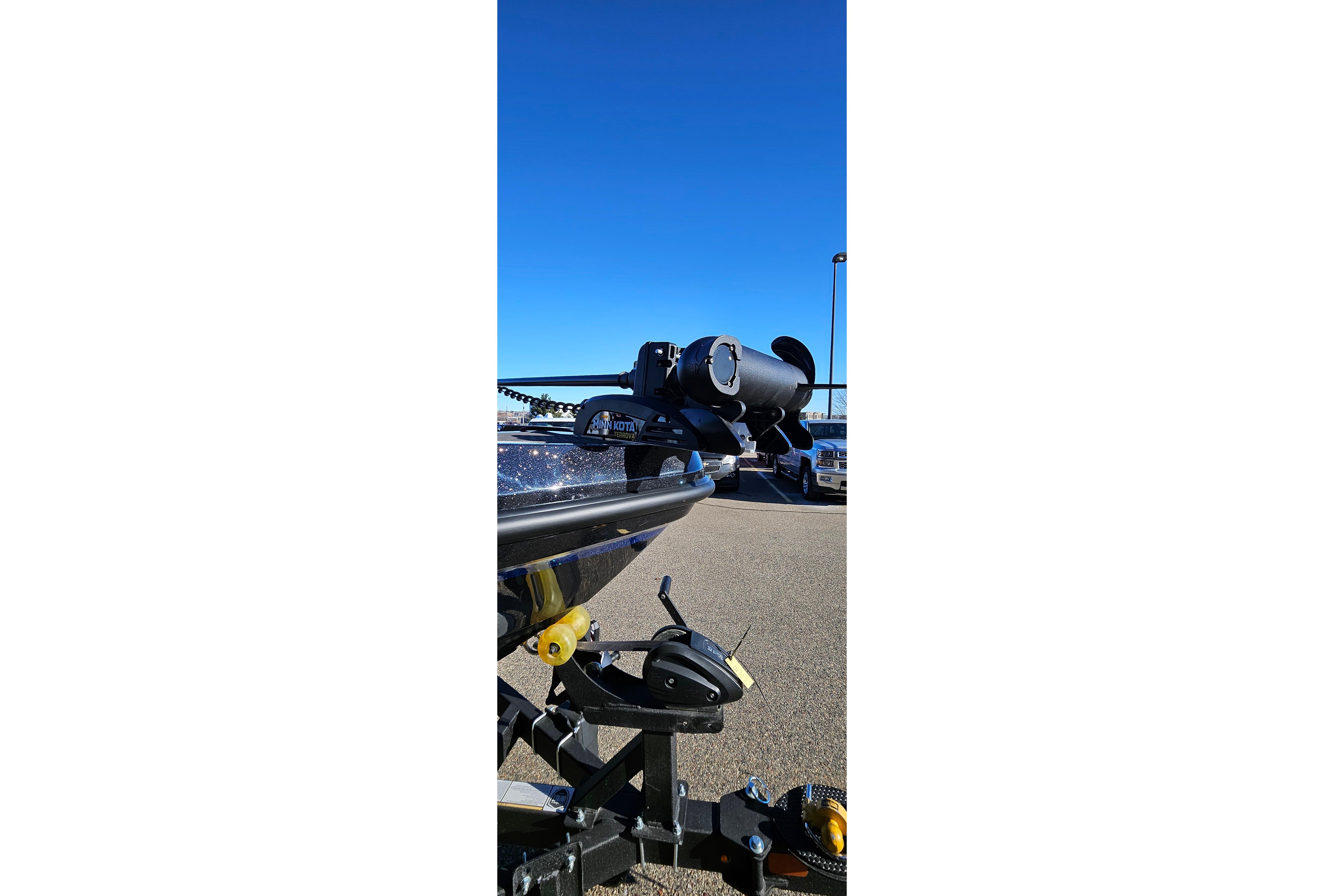 2025 Nitro ZV20 boat trailer with motor, parked under clear blue sky.