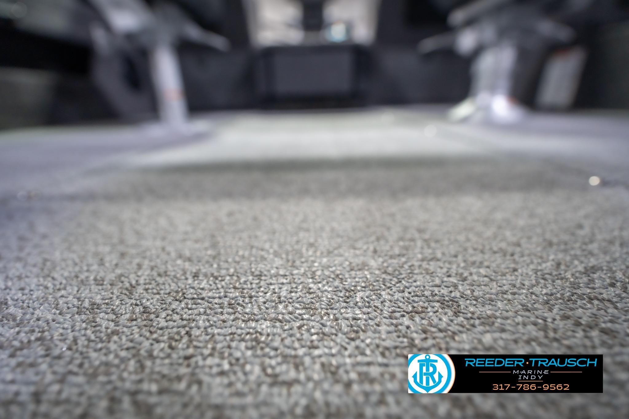 2026 Lund 2075 Impact XS boat interior with carpet flooring, Reeder-Trausch Marine logo visible.