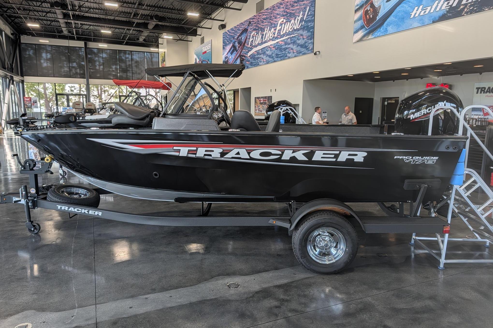 2026 Tracker Pro Guide V-175 Combo boat displayed in showroom, featuring sleek black design.