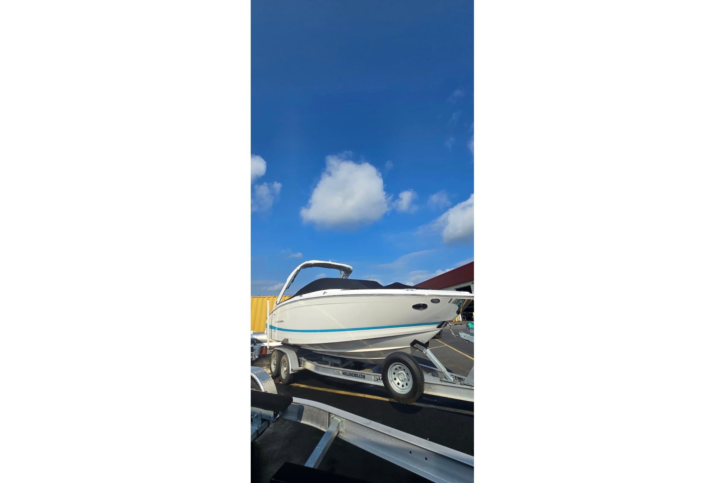 2020 Regal LS6 boat on trailer under clear blue sky.