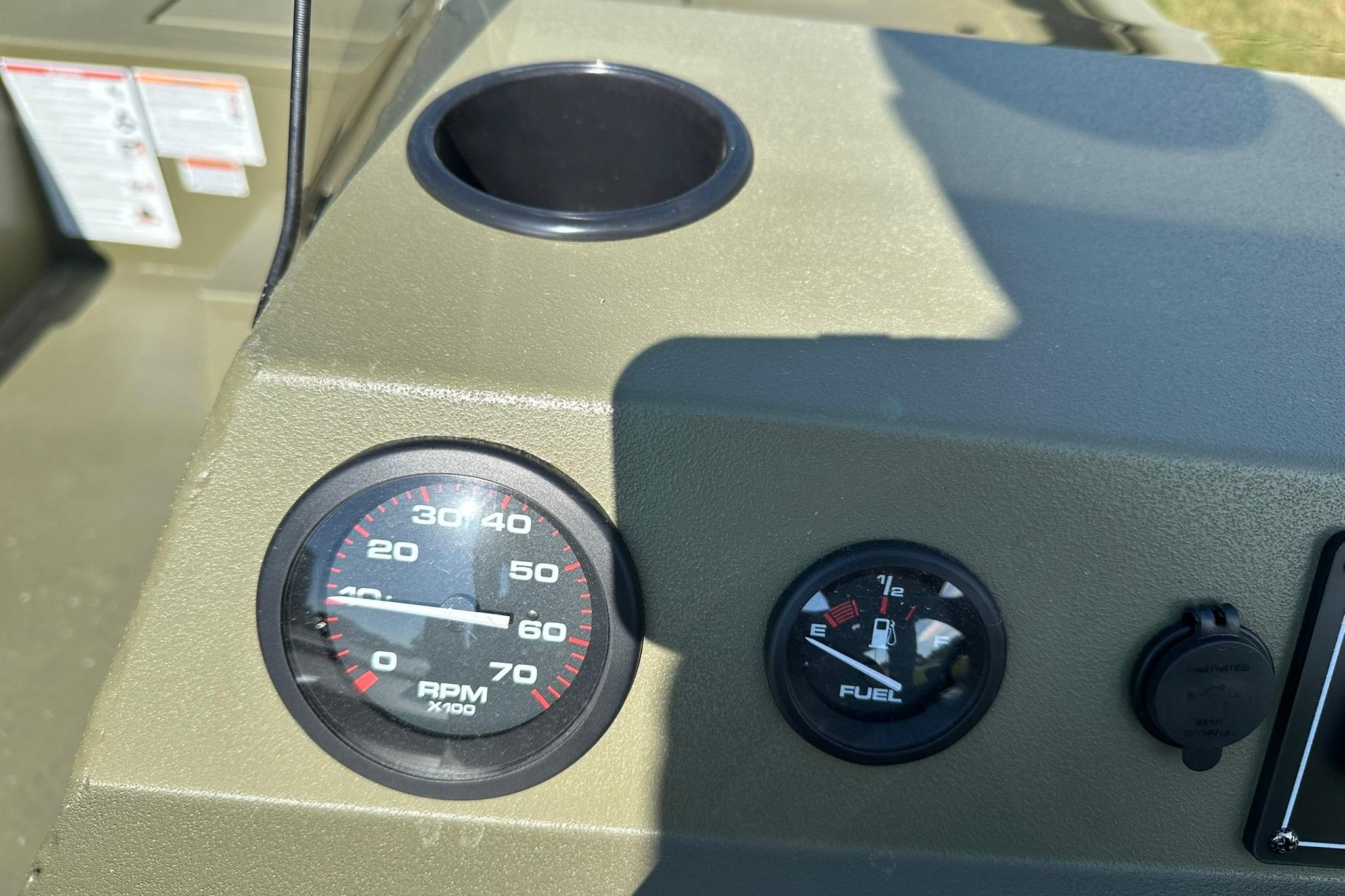Dashboard of 2026 Lowe Roughneck 1860SC boat with RPM and fuel gauges.