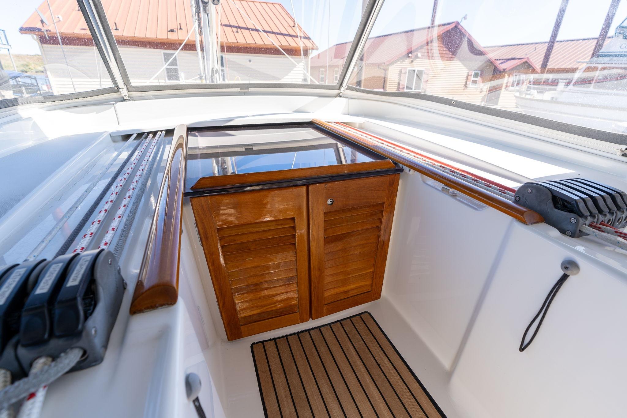 Cockpit view of 2013 Beneteau Oceanis 50 sailboat with wooden hatch and deck.