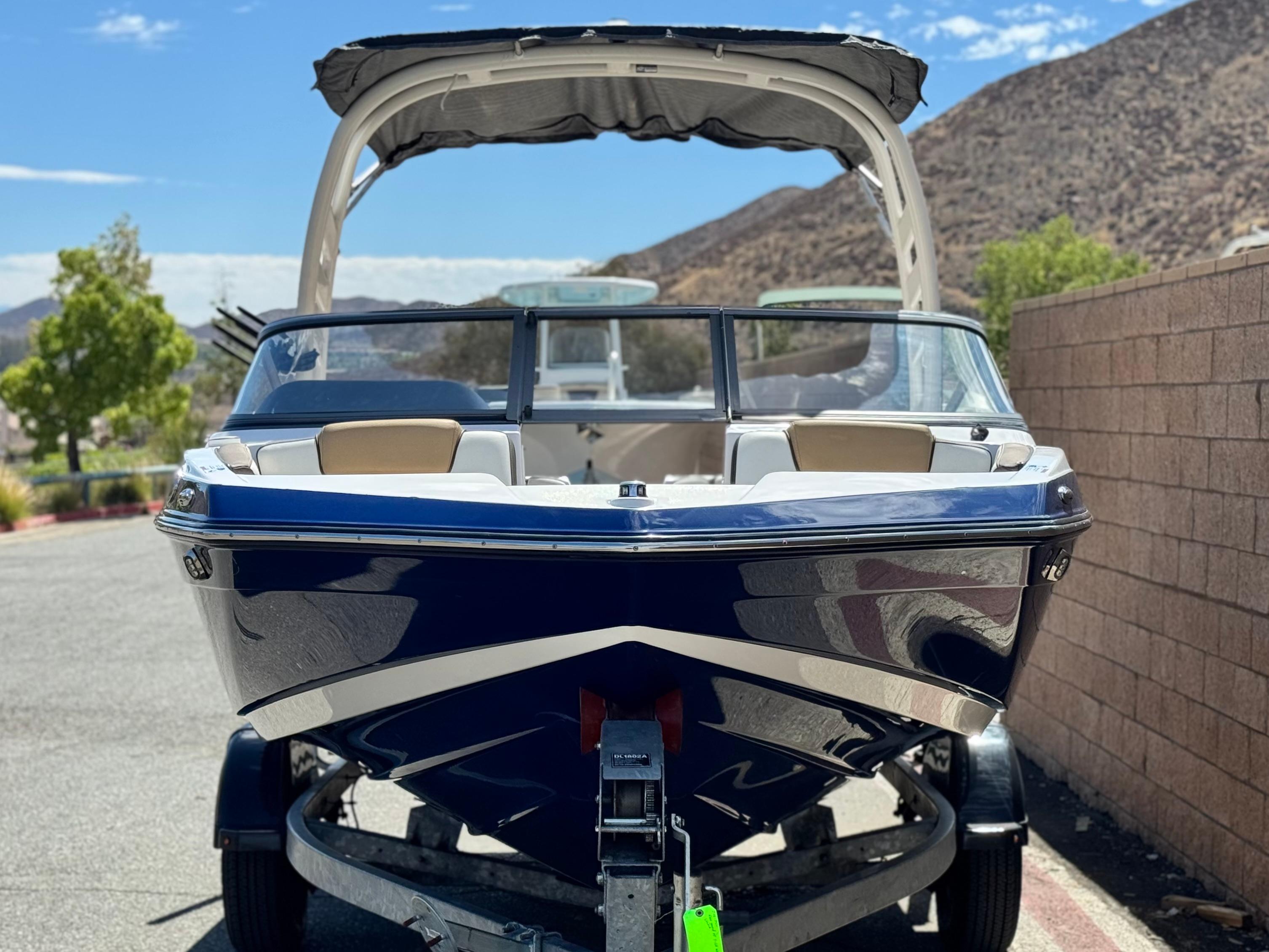2022 Yamaha Boats AR 195 S on trailer, parked outdoors with scenic mountain backdrop.