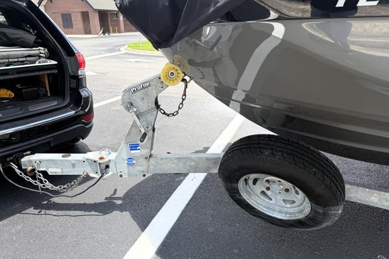 2017 Yamaha Boats SX210 on trailer hitched to SUV in parking lot.