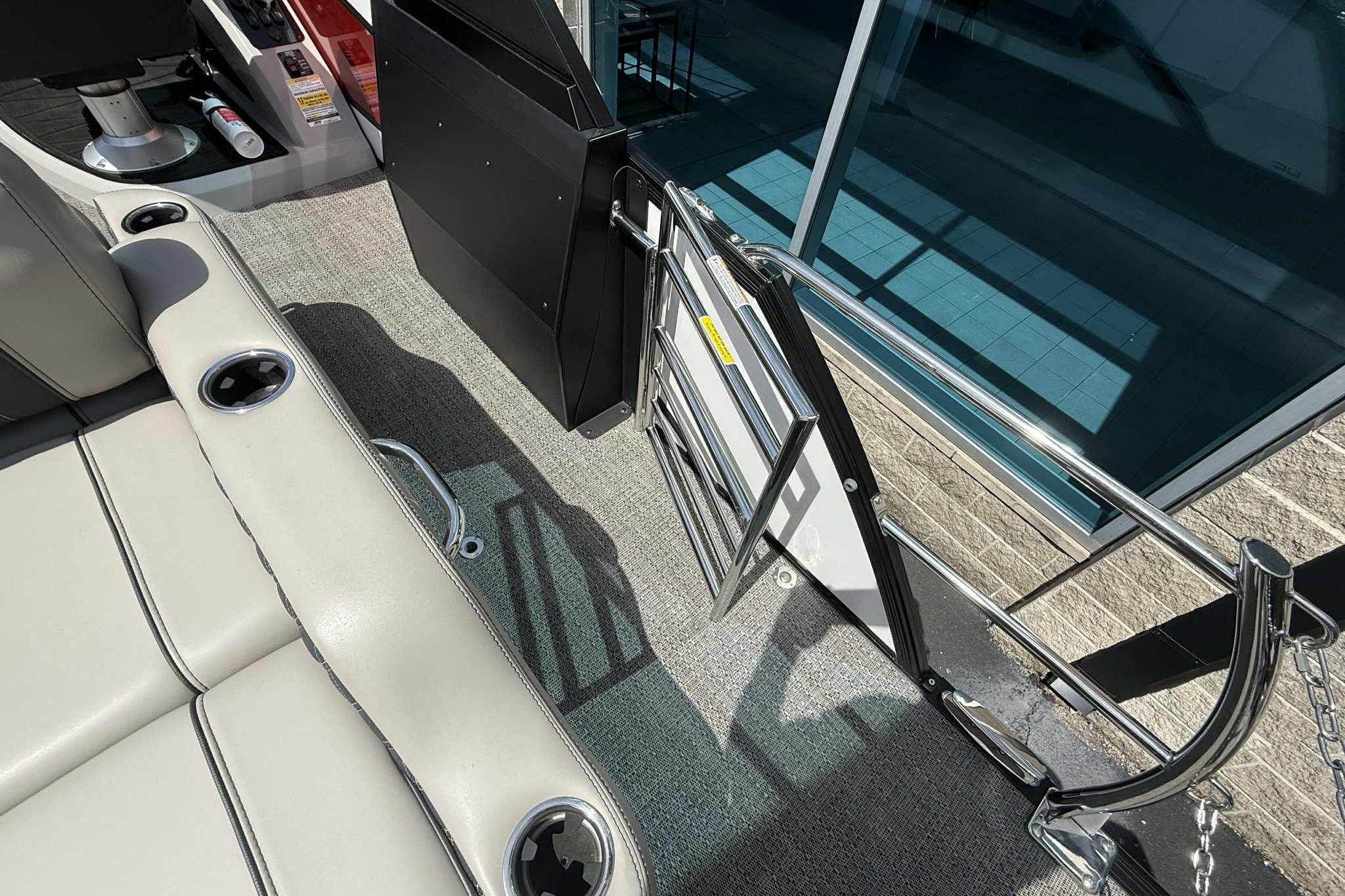 Interior view of 2026 Barletta LUSSO 25UCAT boat, featuring seating and open gate.
