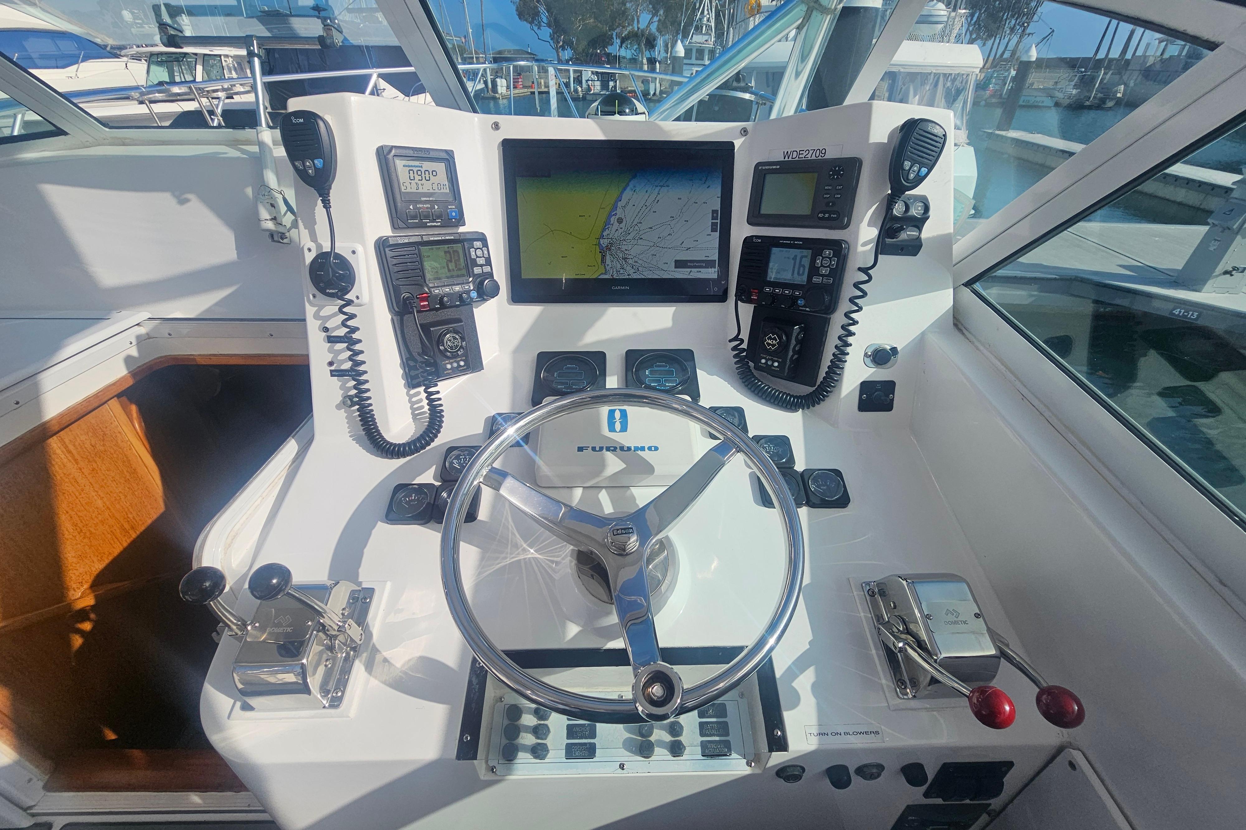 Helm of 2003 Topaz 32 Express boat with navigation equipment and steering wheel.