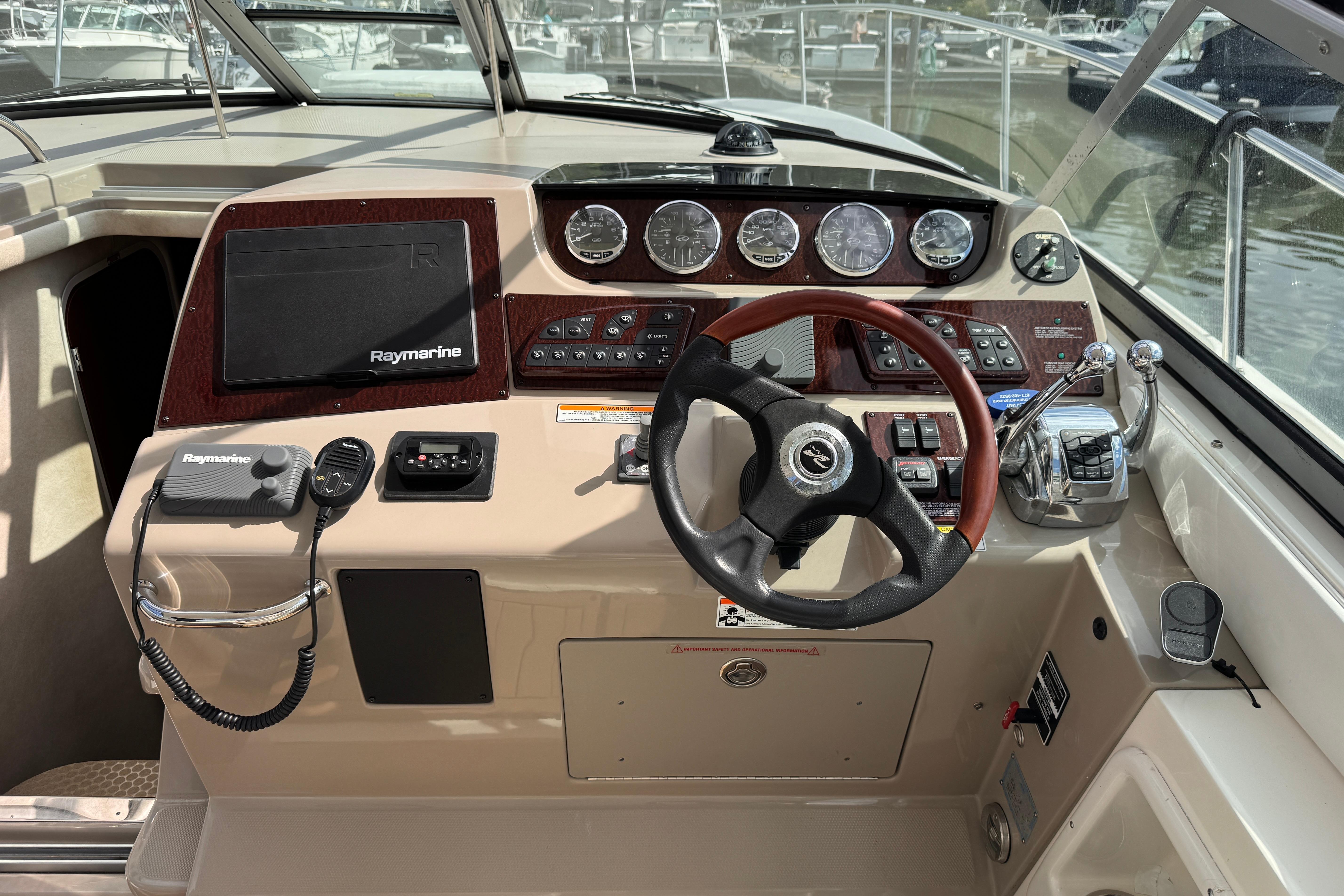 Cockpit of 2008 Sea Ray Sundancer 350 with steering wheel and navigation controls.