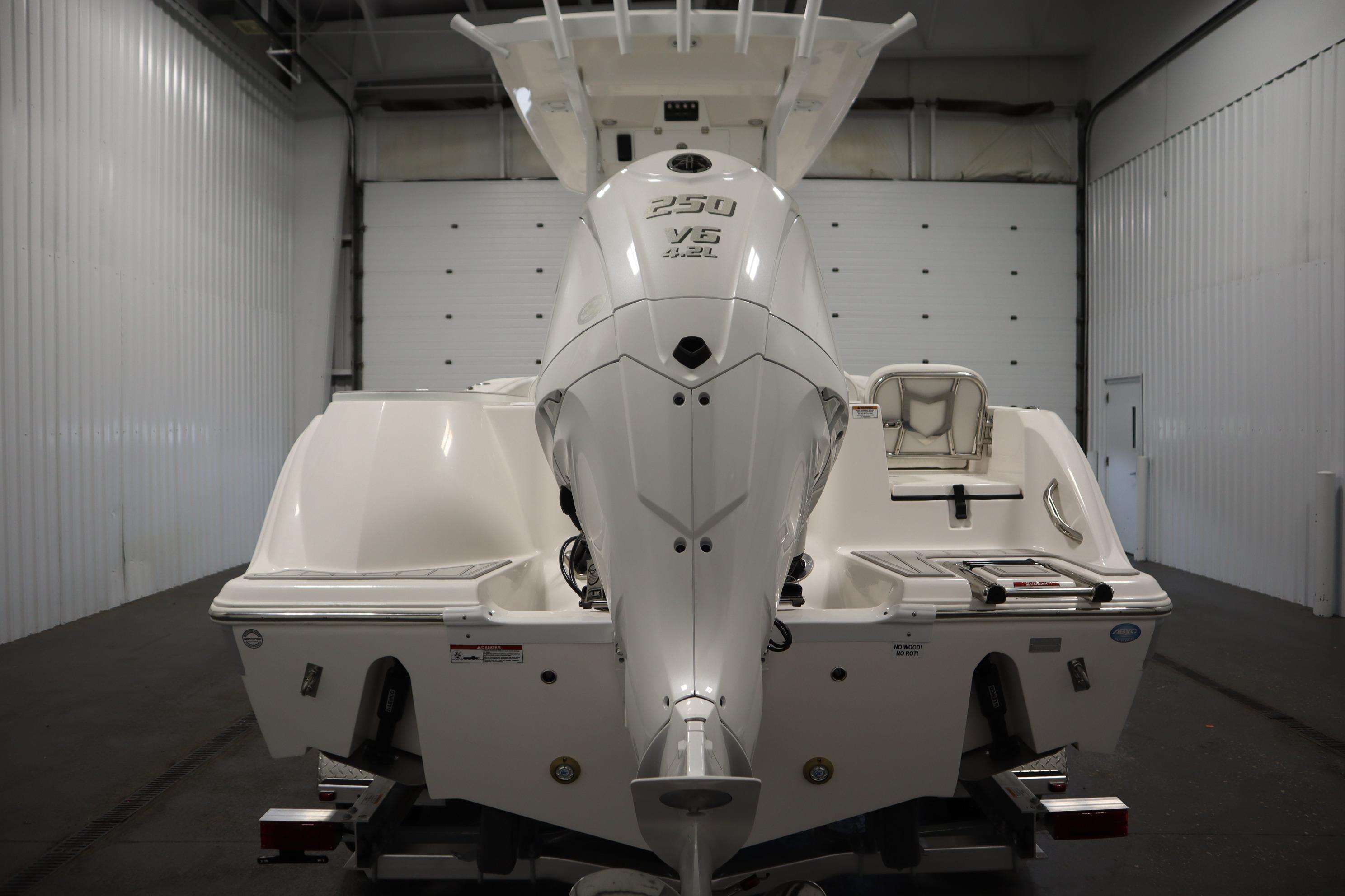 2026 Sea Fox 228 Commander boat with powerful 250 V6 engine in a garage.