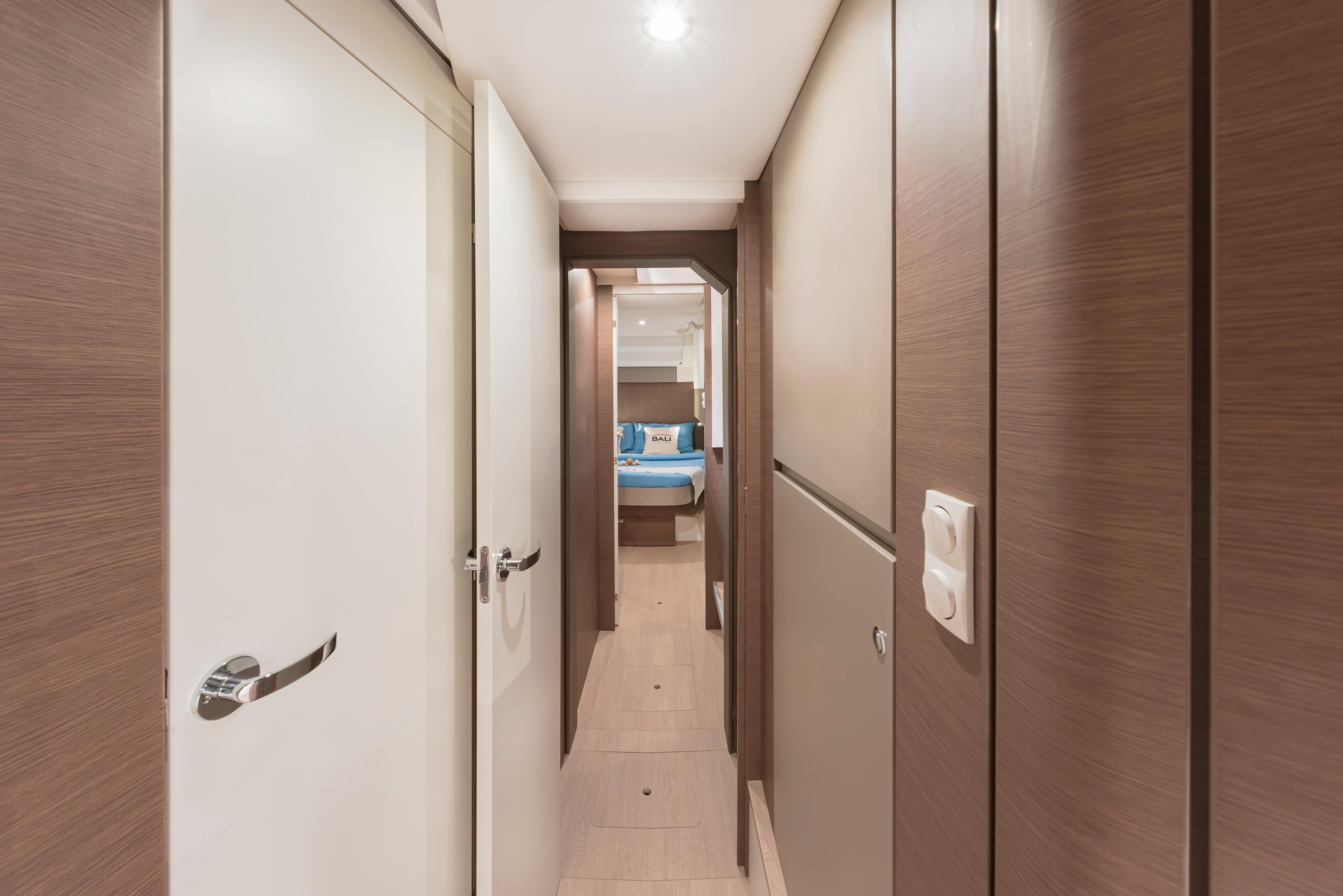 Hallway inside 2025 Bali CATSPACE SAIL yacht, featuring modern wood paneling and sleek design.