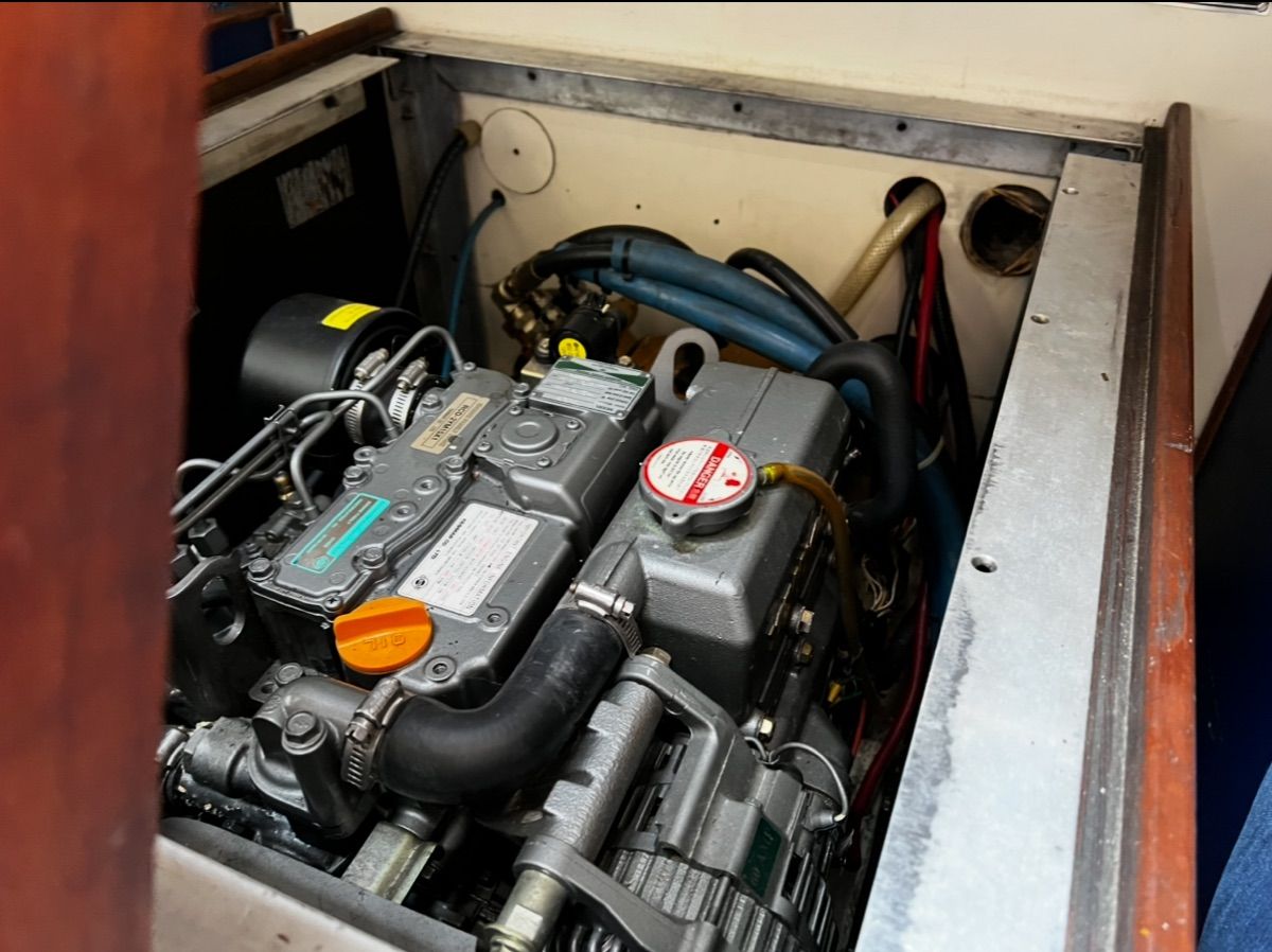 Boat engine compartment with visible engine and hoses.