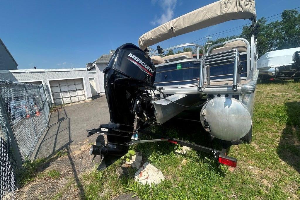 2023 Sun Tracker Bass Buggy 18 DLX pontoon boat with Mercury outboard motor.