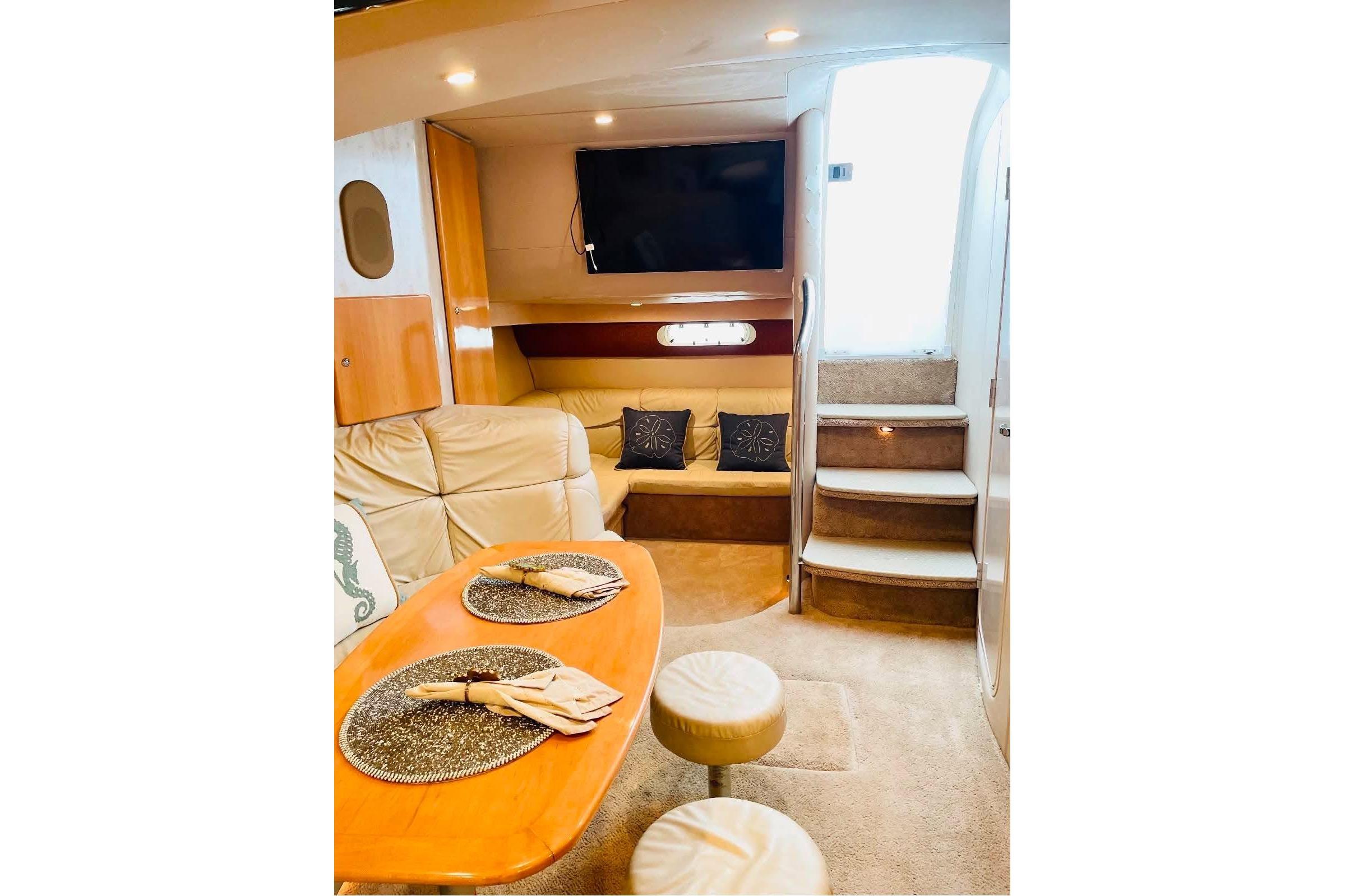 Interior of a 2003 Formula 40 Performance Cruiser with cozy seating and elegant dining setup.