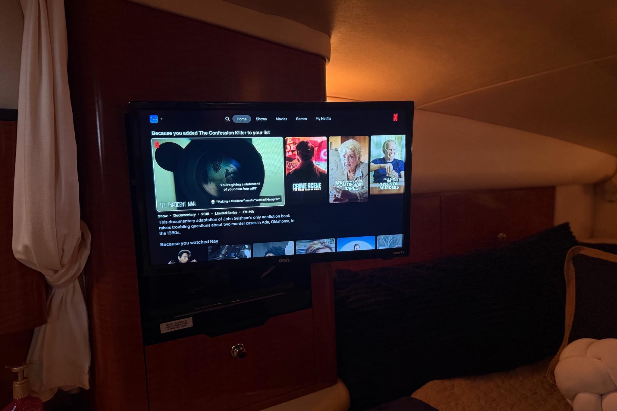 TV screen inside a 2002 Sea Ray Sundancer 320 yacht displaying Netflix recommendations.