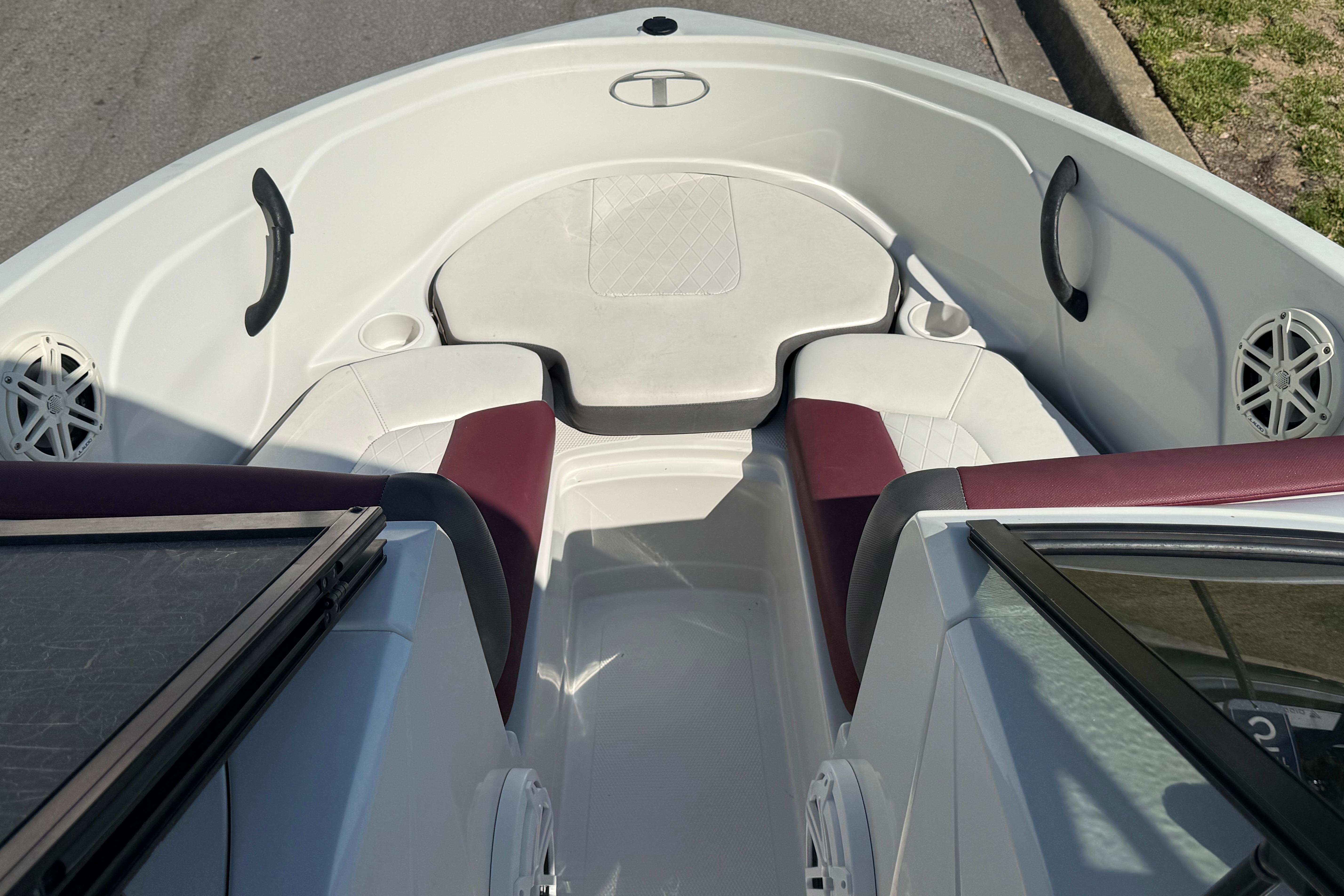 Interior view of a 2016 Tahoe 400 TS boat with white and maroon seating.