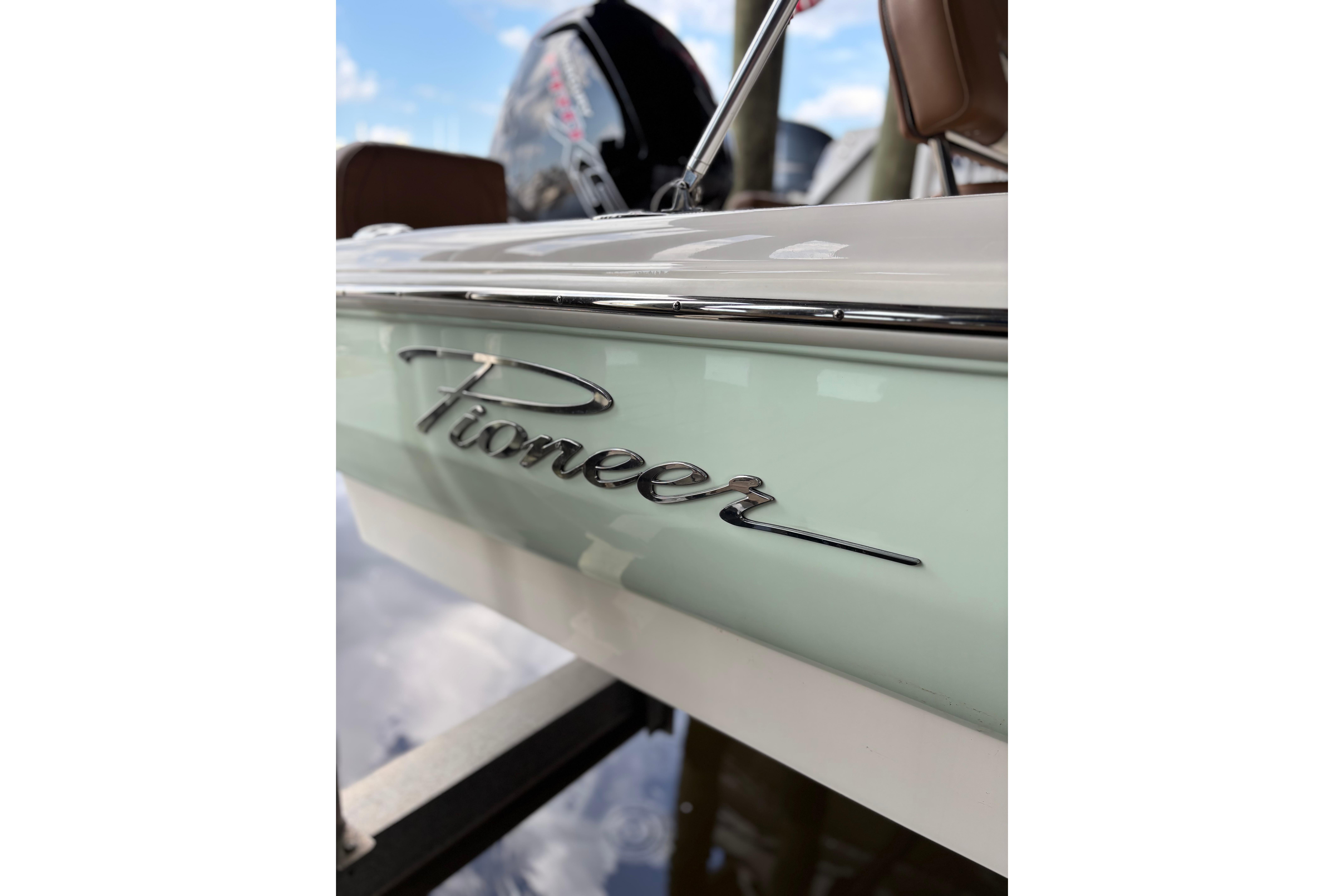 2024 Pioneer 180 Islander boat with sleek design and chrome logo detail.