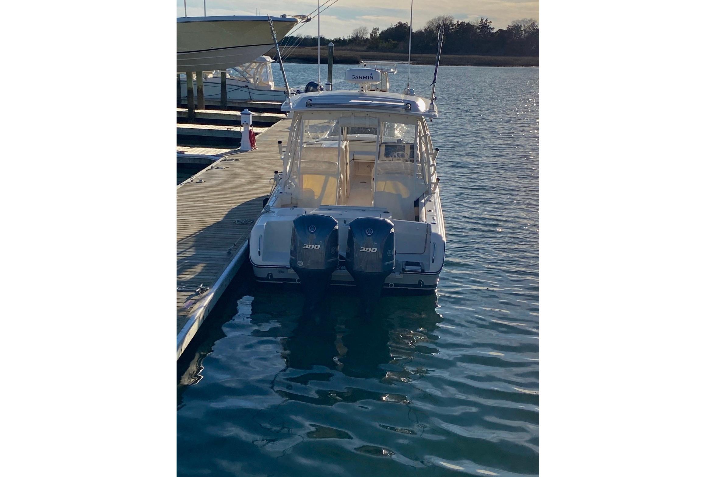 2020 Grady-White Freedom 285 boat docked with twin 300 horsepower engines.