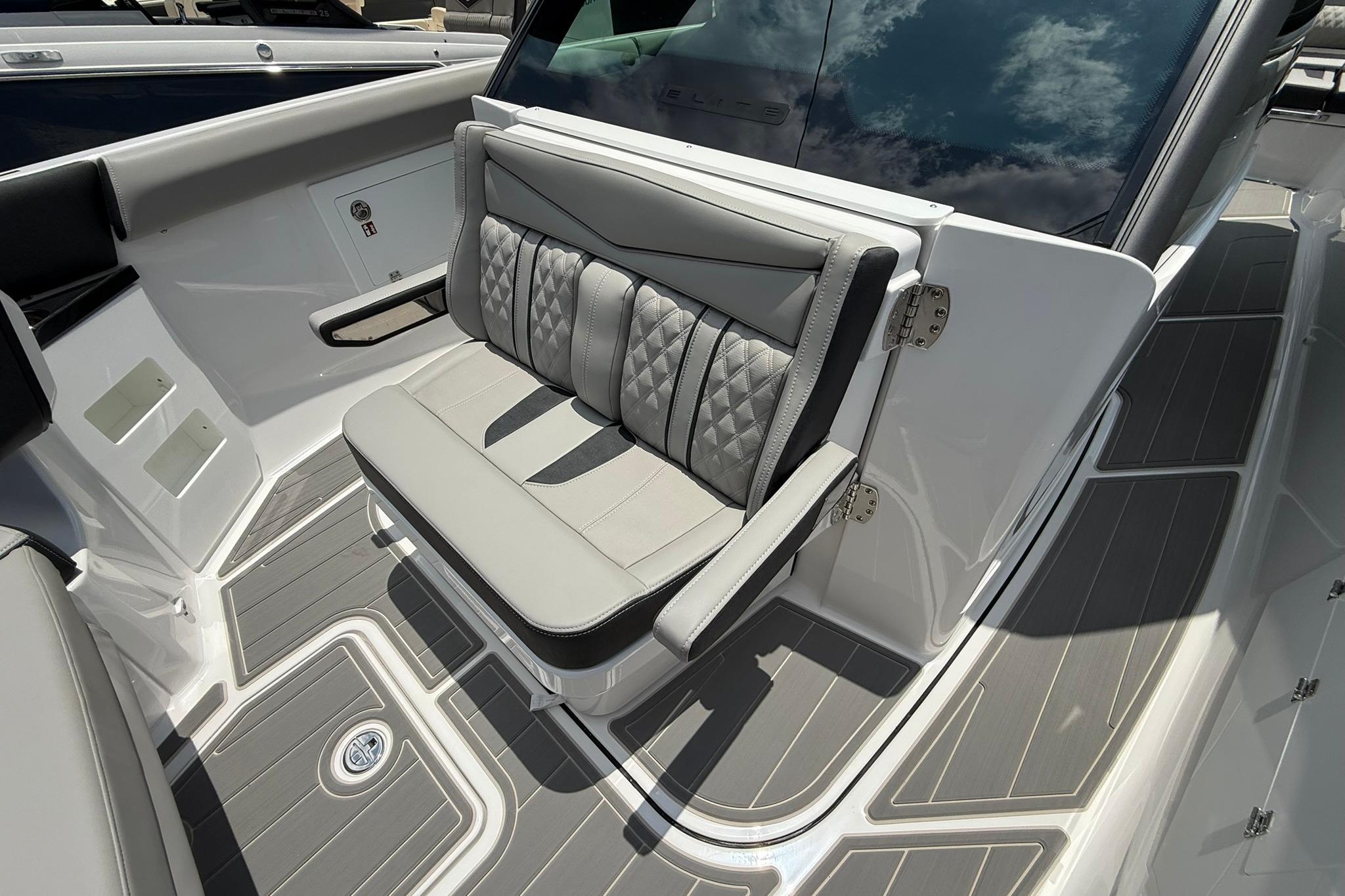 Luxury seating on 2027 Monterey Elite 30 OB boat, featuring sleek design and premium materials.