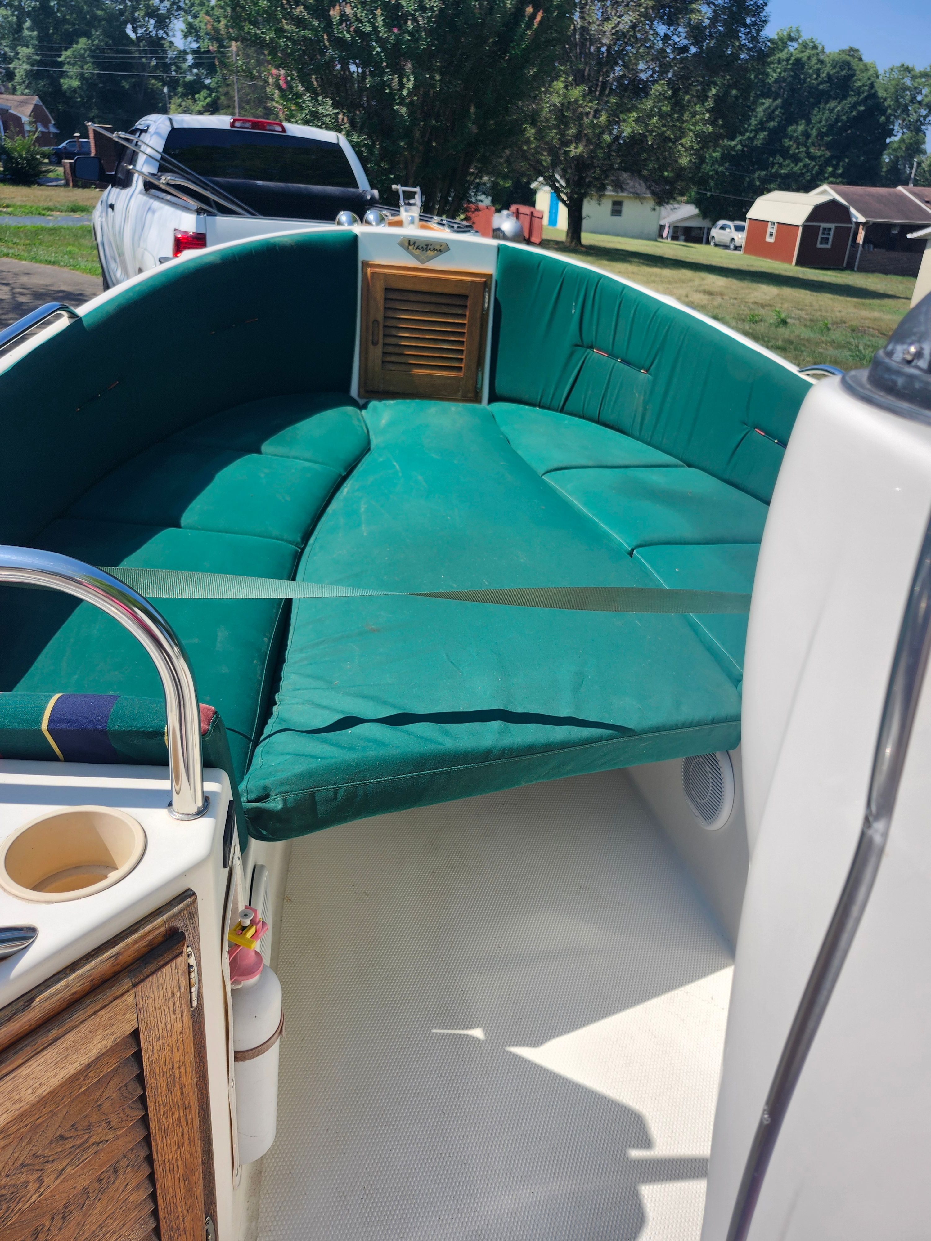 Green cushioned seating in the open cockpit of a 2000 Ranger Tugs Martini 21 Launch.