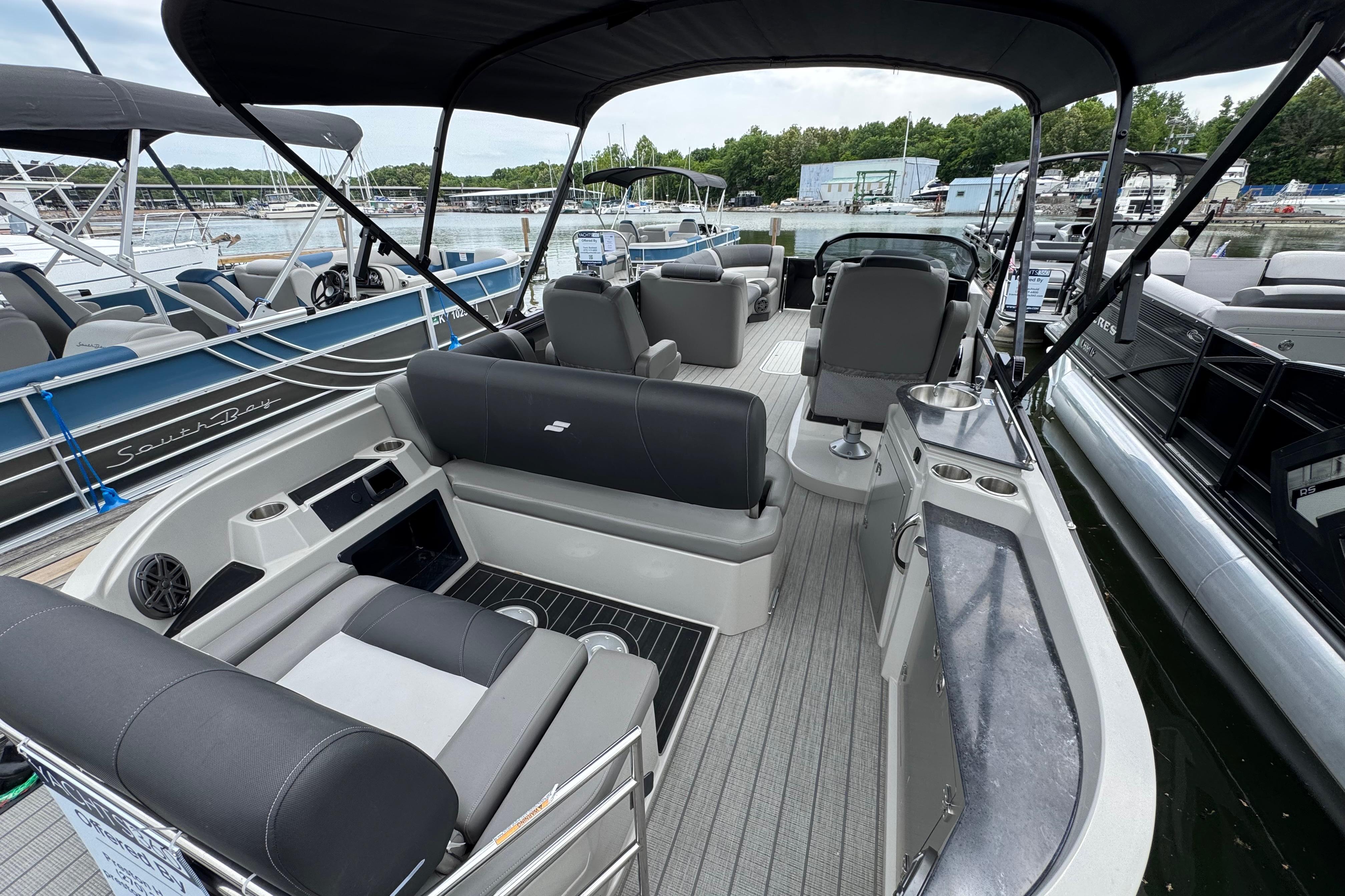 2023 Starcraft MX 25 DL DH pontoon boat interior with seating and helm, docked at marina.