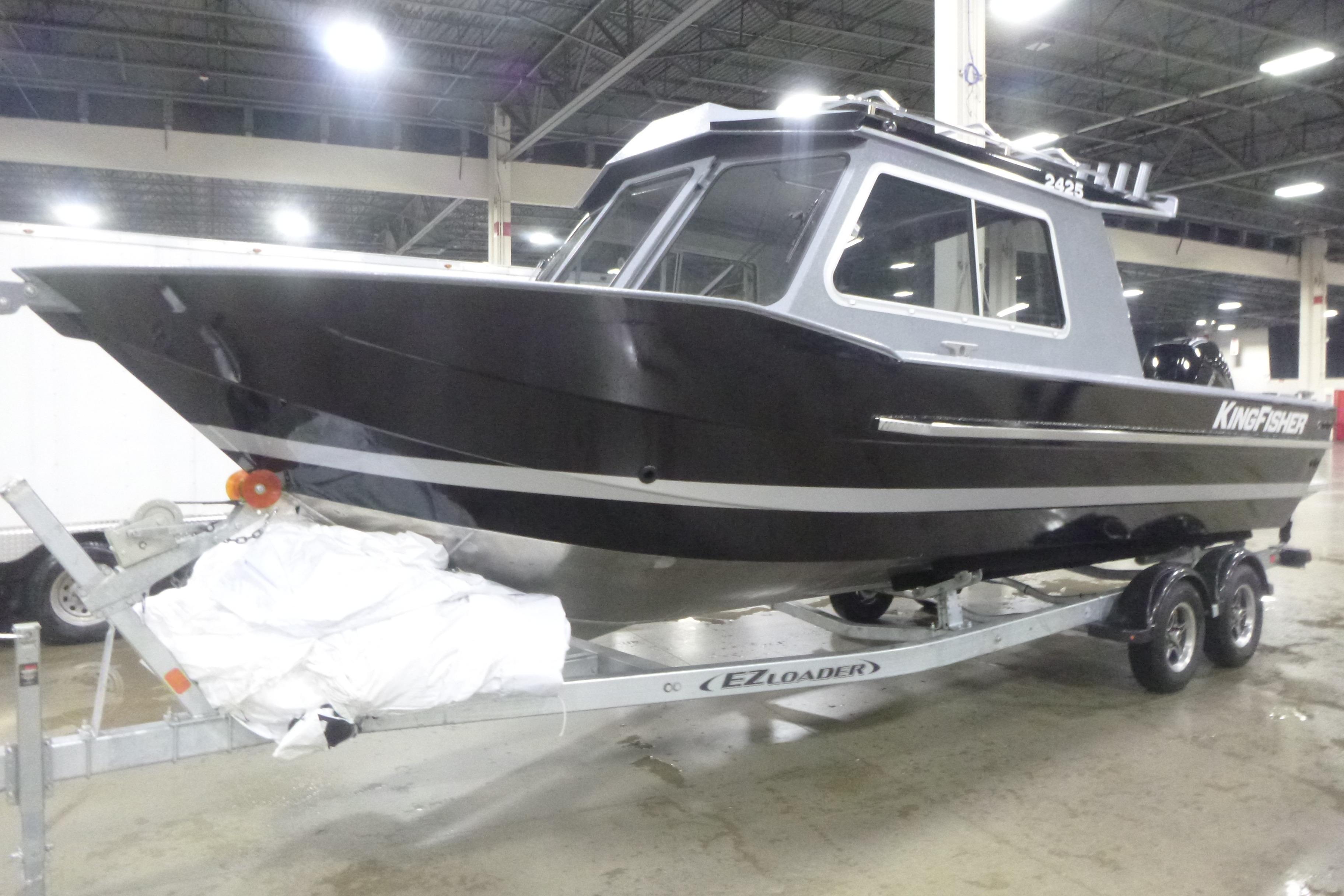 2026 KingFisher 2425 Escape HT boat on trailer in indoor showroom.