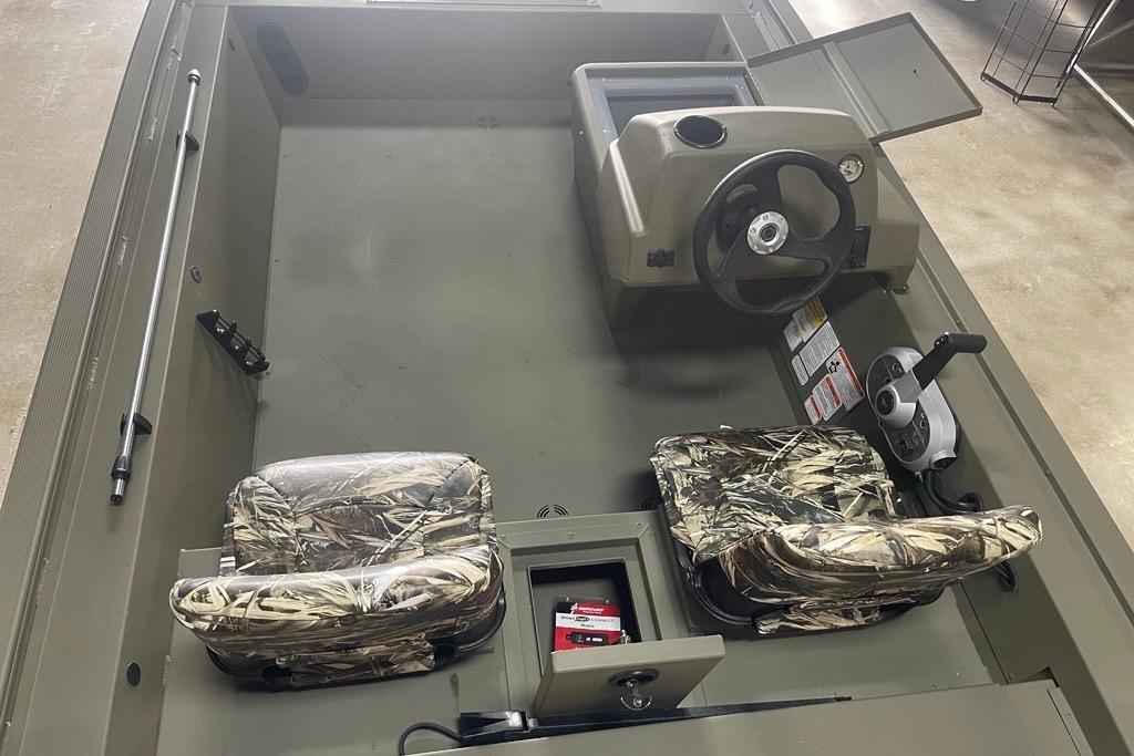 2026 Tracker Grizzly 1754 SC boat interior with camo seats and steering console.