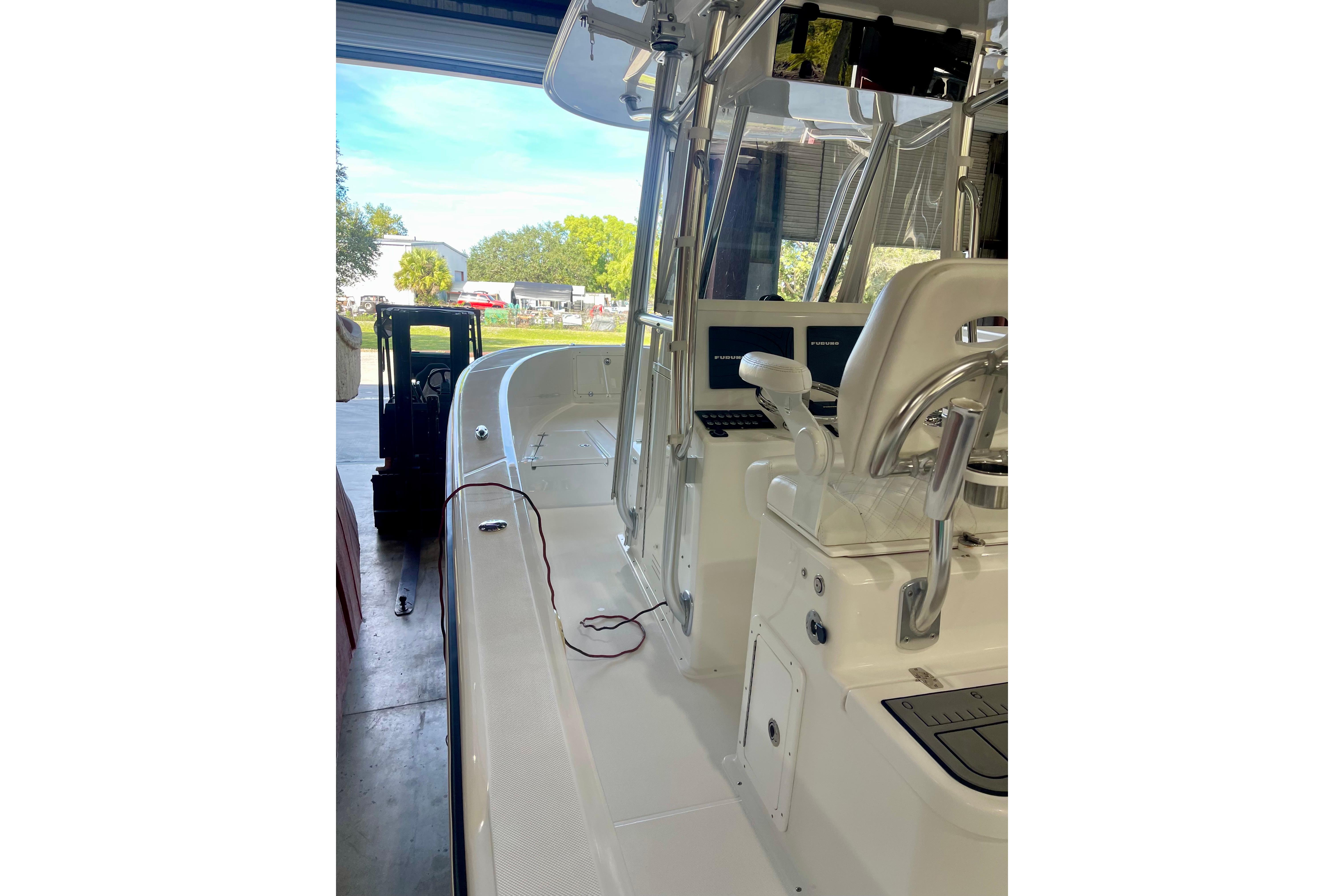 2025 Ocean Master 296 Center Console boat in a garage setting.