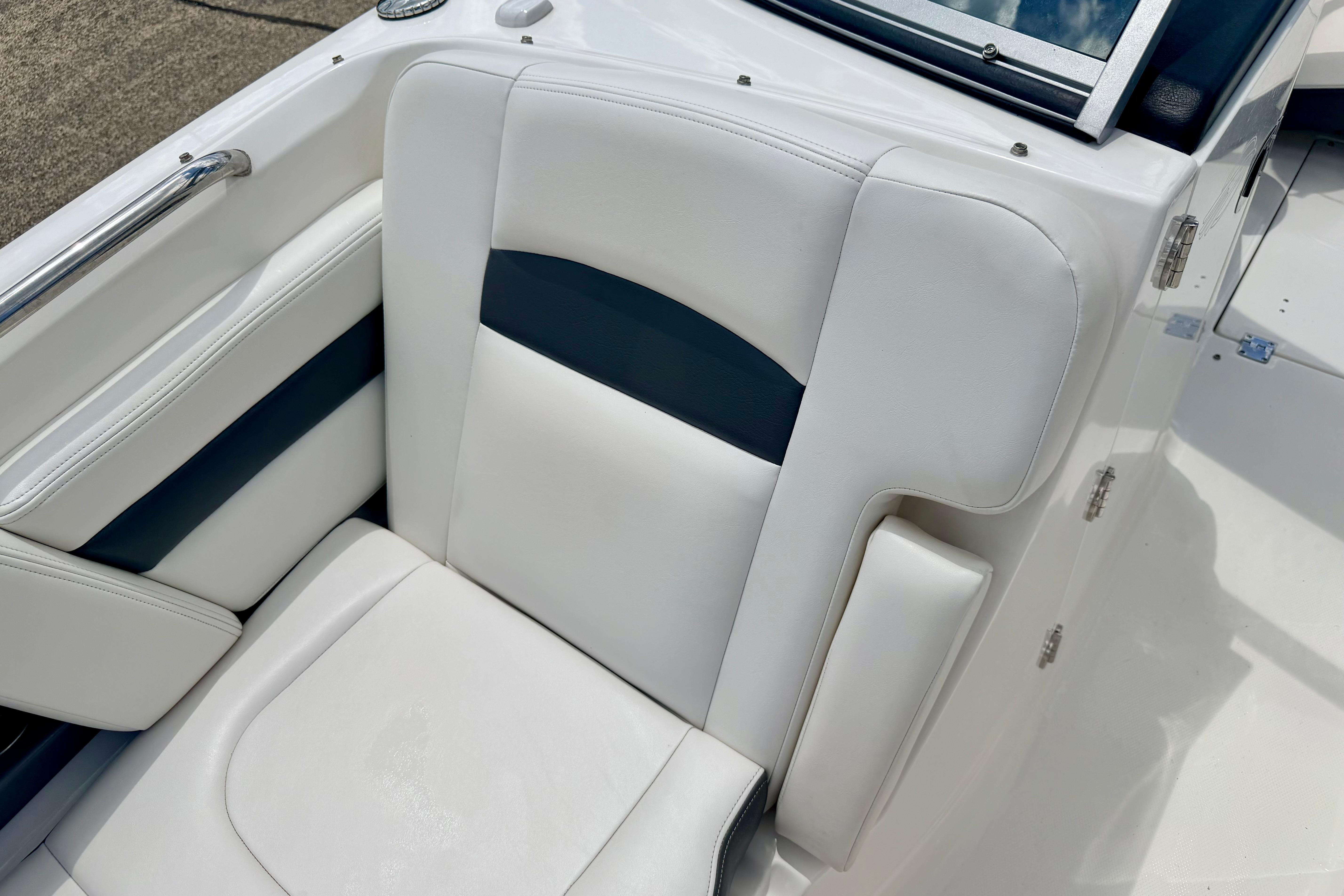2015 Chaparral Sunesta 264 boat seat with white and navy upholstery.