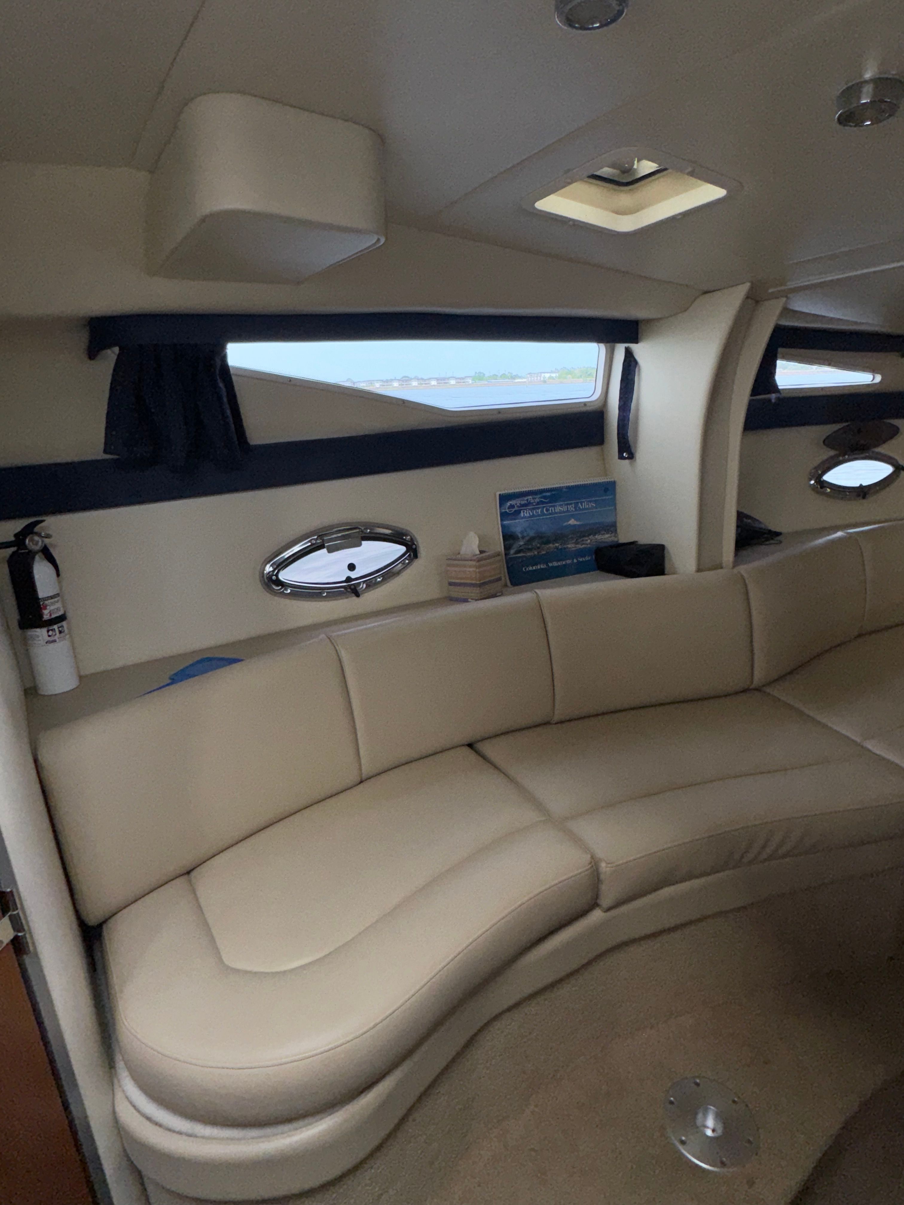Interior of a 2008 Bayliner 340 with cream sofa.