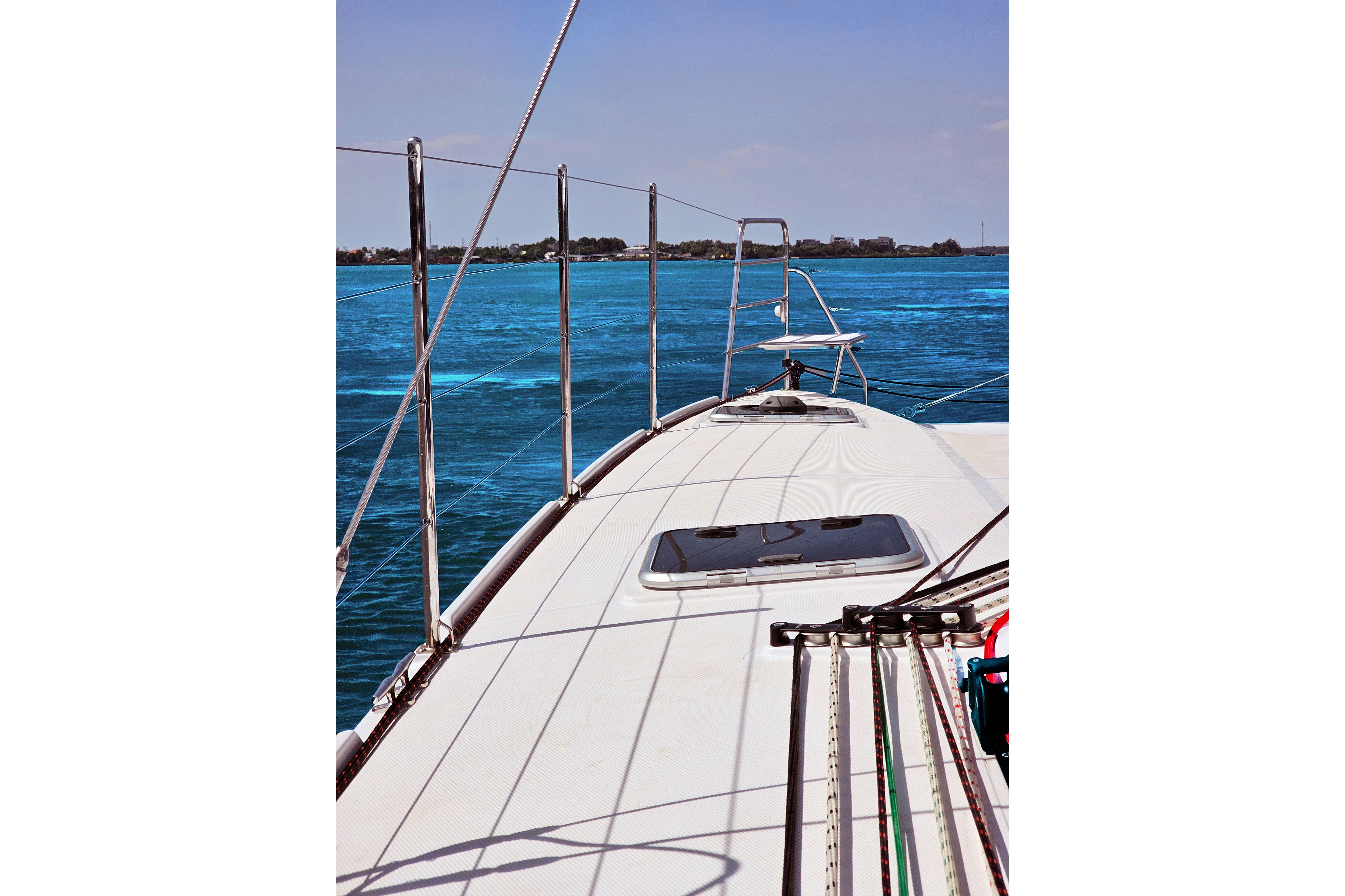 Seawind 1160XL catamaran deck view, sailing on clear blue waters, 2026 model.