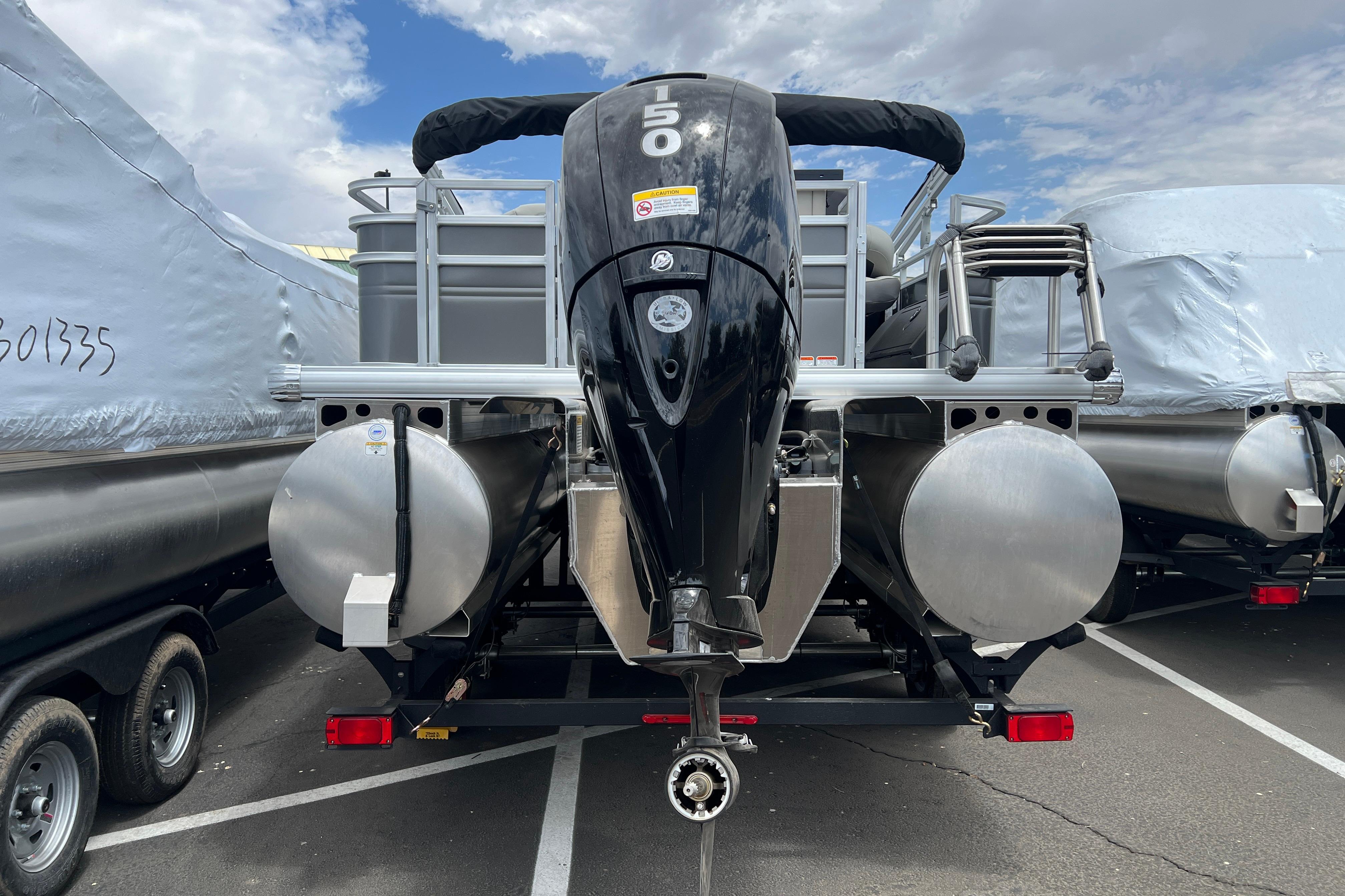 2026 Sun Tracker Fishin' Barge 22 XP3 pontoon boat with powerful outboard motor.