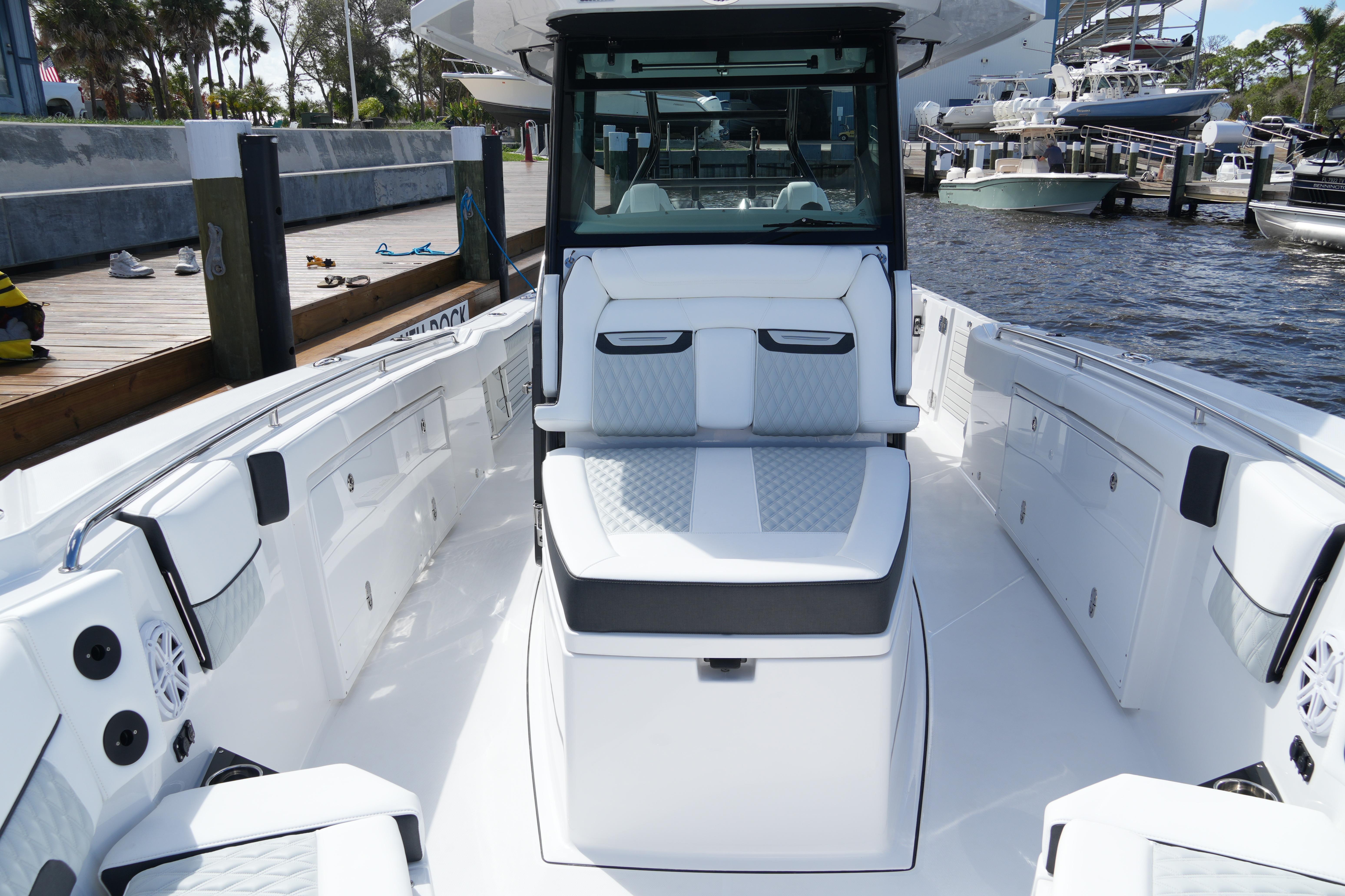 2026 Blackfin 332 CC boat interior with sleek seating and modern design at a marina.