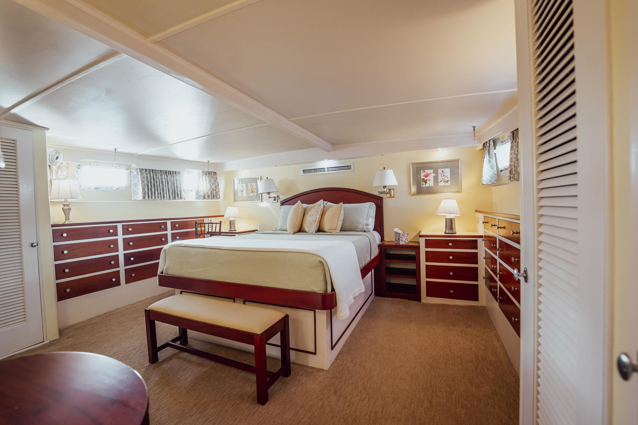 Luxurious bedroom interior on a 1972 Trumpy 72 Motor Yacht with elegant furnishings.