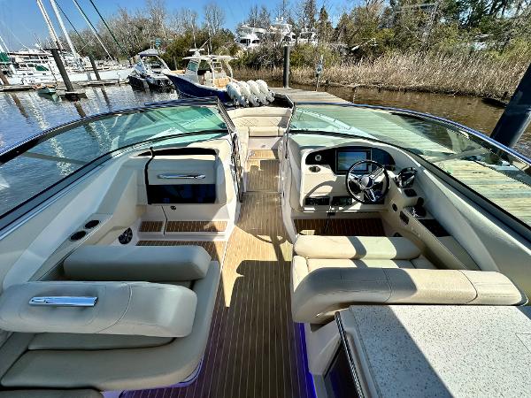 The image shows the cockpit of a 2018 Regal 3300 boat with beige seats and a modern dashboard.