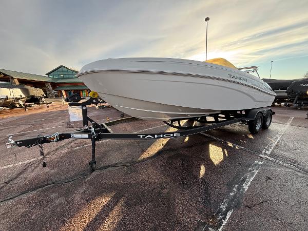 2024 Tahoe T21 boat on trailer in parking lot at sunset.