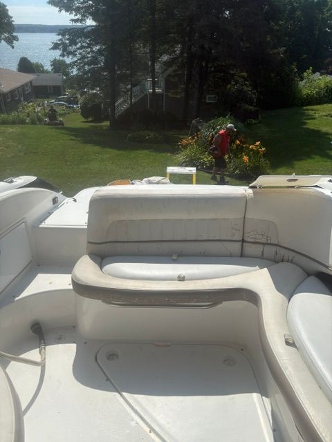 The image shows the cockpit of a 2003 Cobalt 240 boat with white seating.